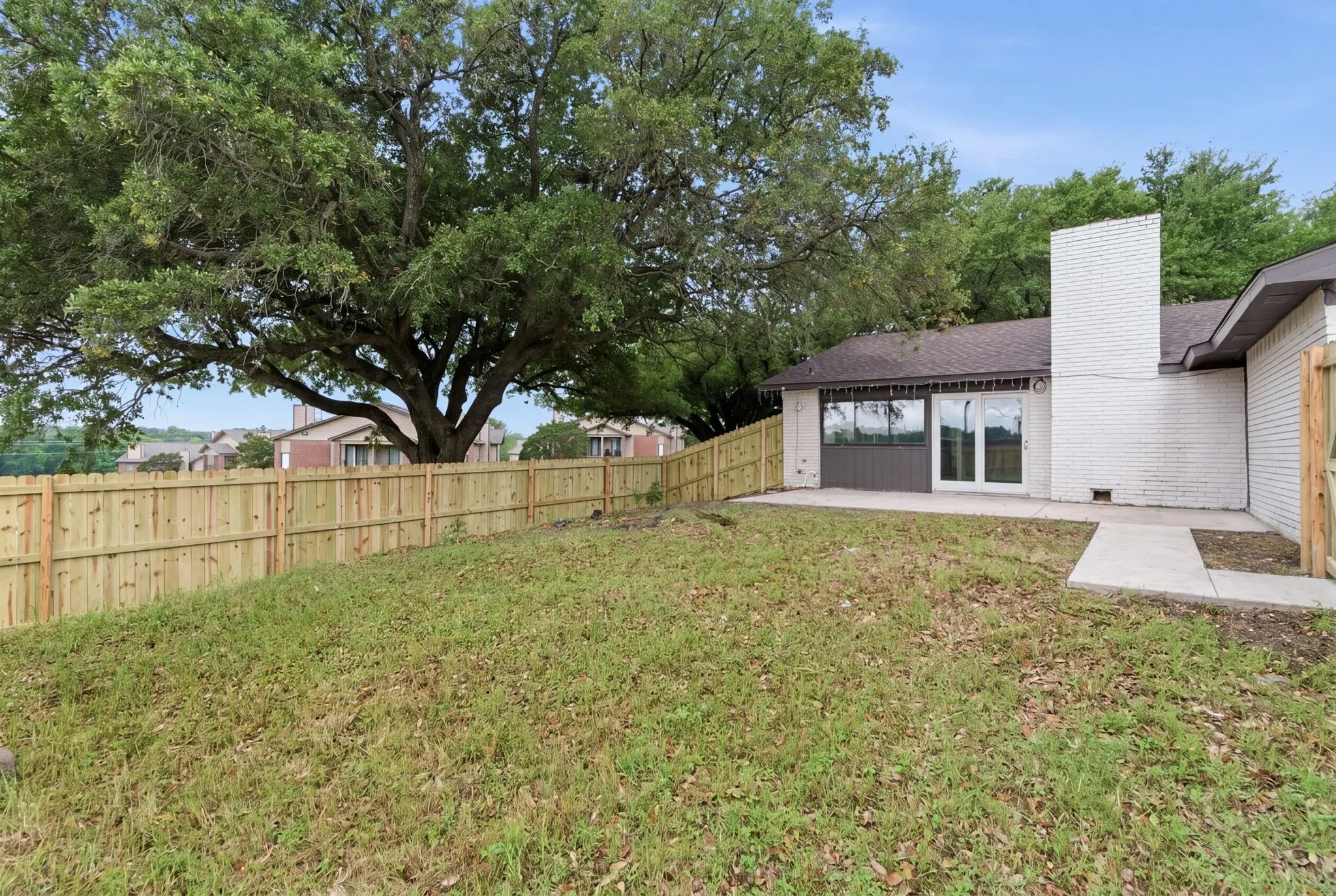 Expansive backyard featuring a new wood privacy fence