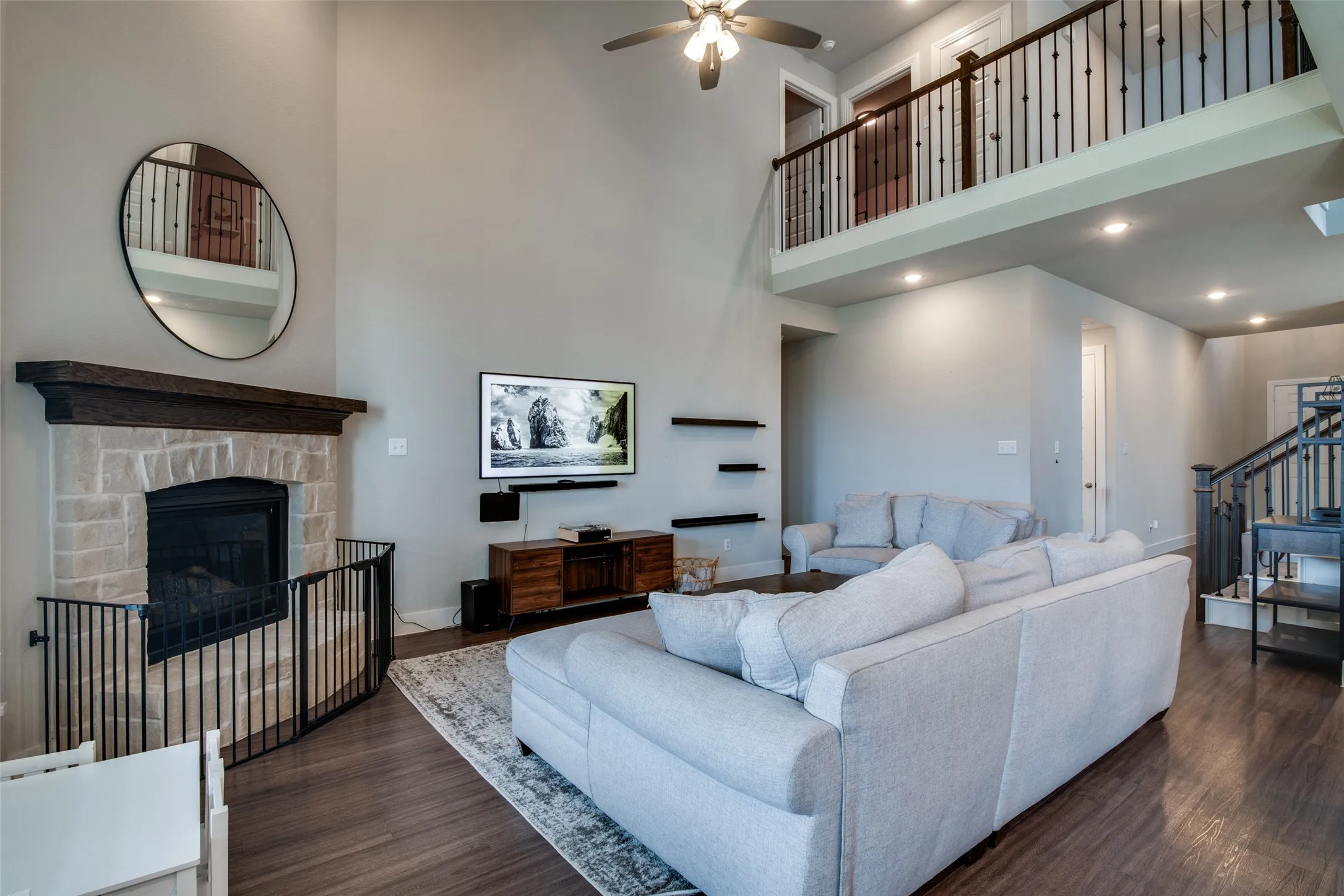 Soaring ceilings featuring a ceiling fan with light fixture