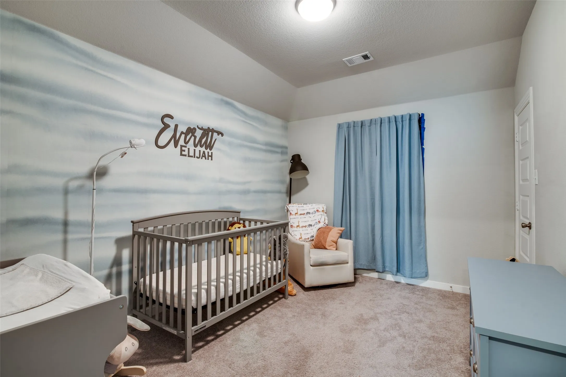 Interior room featuring a tray ceiling, recessed lighting, and soft gray carpeting
