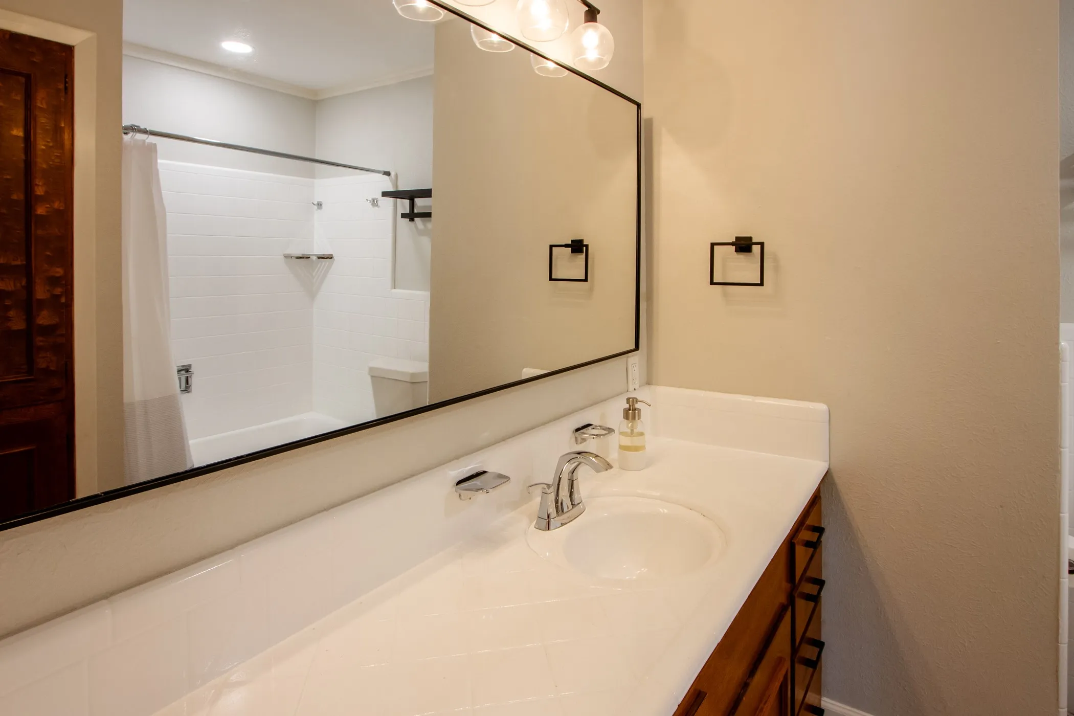 Full bathroom featuring vanity, shower / bathtub combination with curtain, and ornamental molding