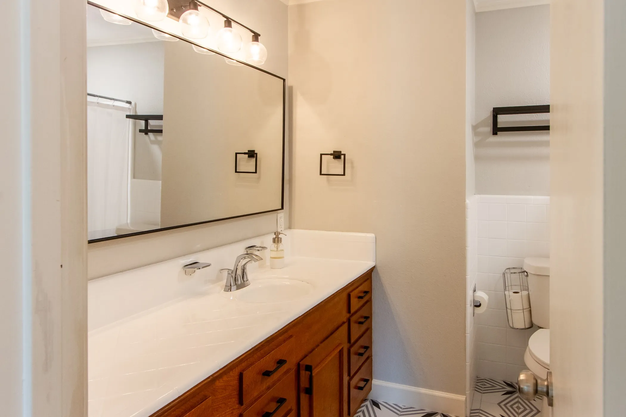Bathroom with vanity, toilet, crown molding, tile walls, and a shower with curtain