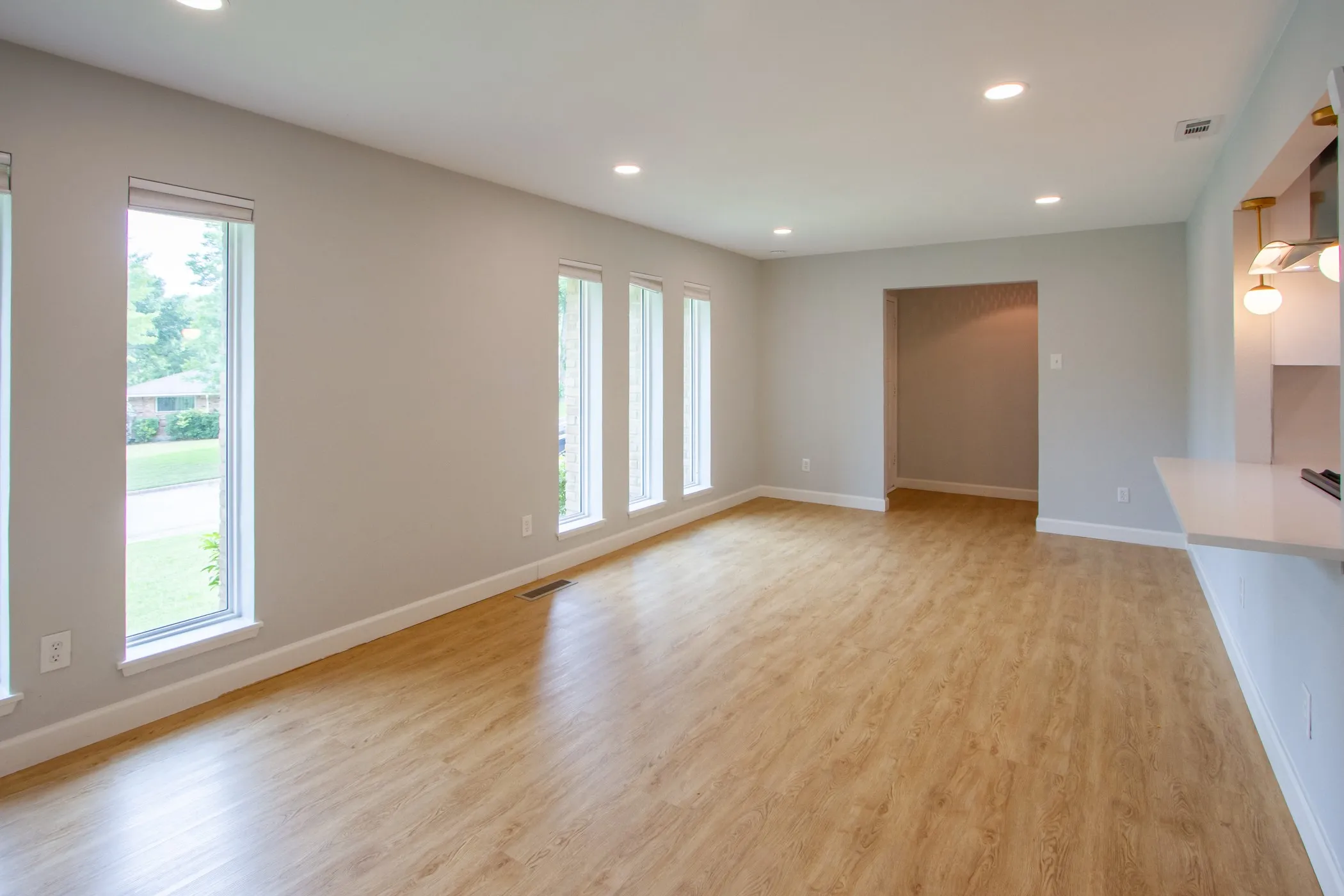 Unfurnished living room with recessed lighting, baseboards, and light wood-style floors