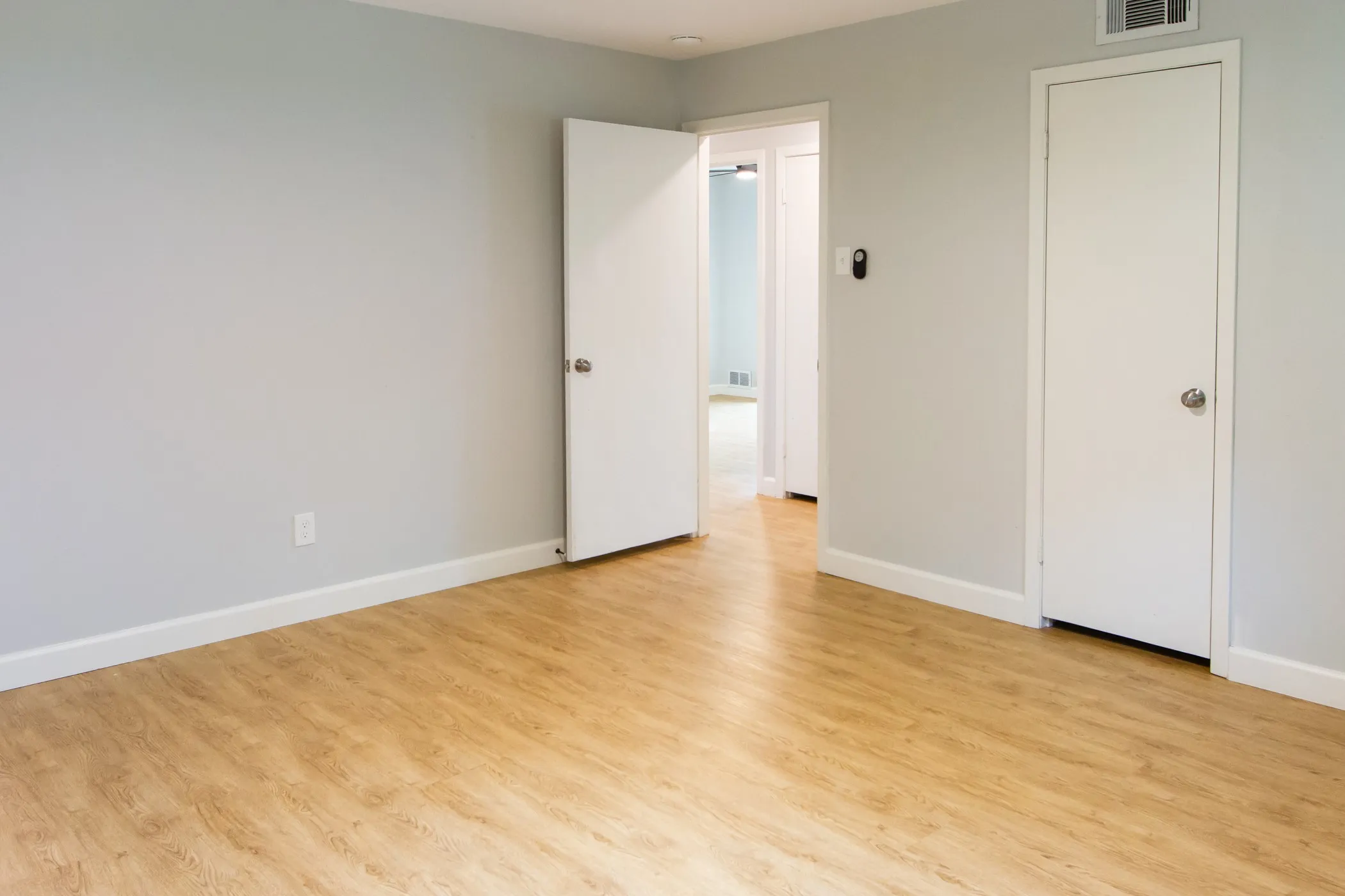 Unfurnished bedroom featuring light wood-type flooring and baseboards