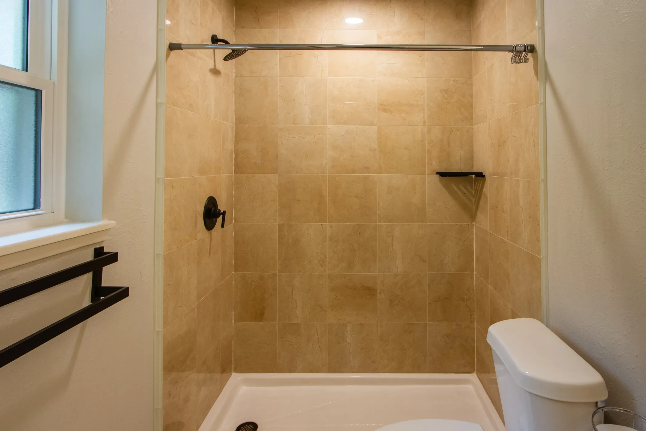 Bathroom featuring toilet and a stall shower