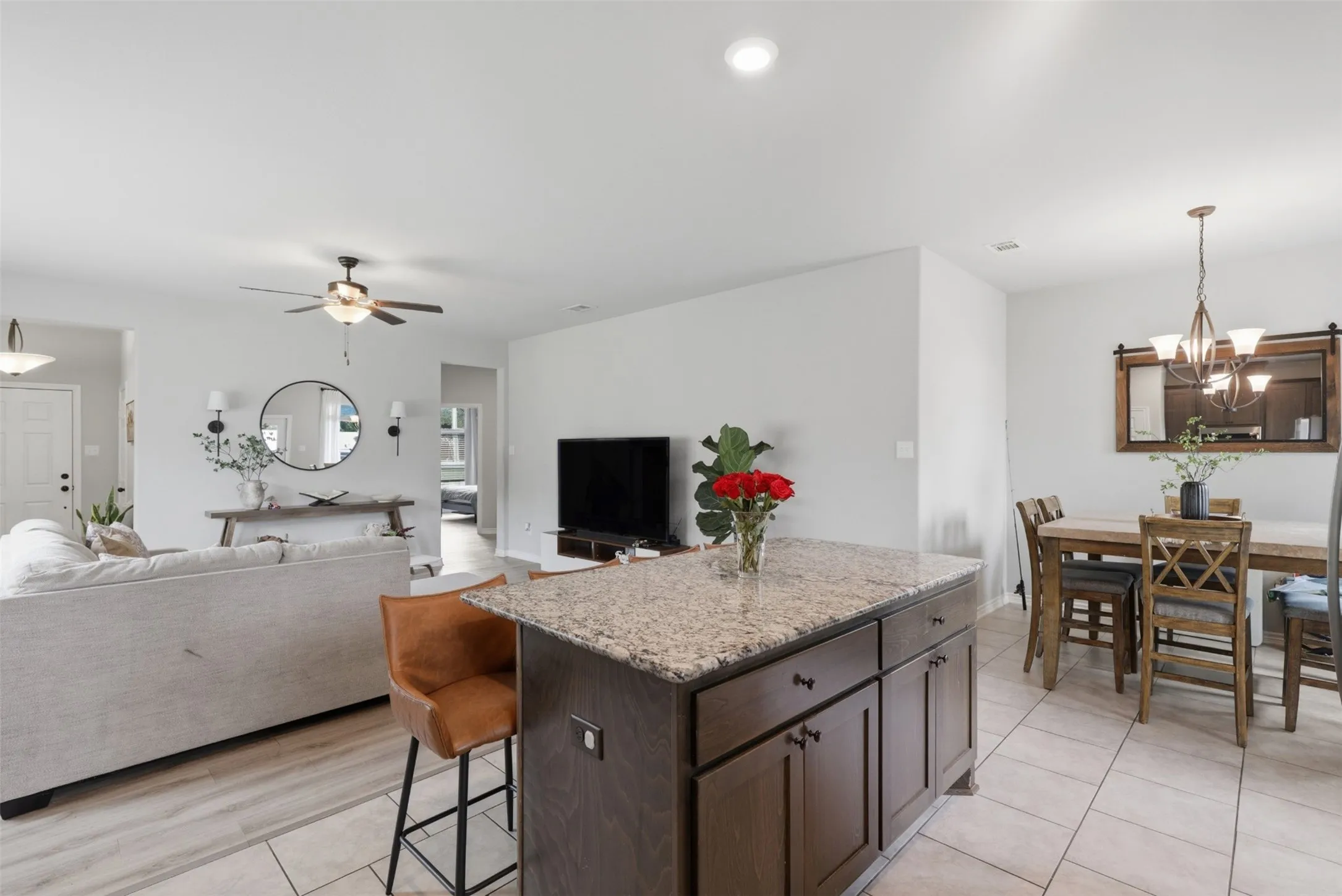 Kitchen island with granite countertop and dark wood cabinetry