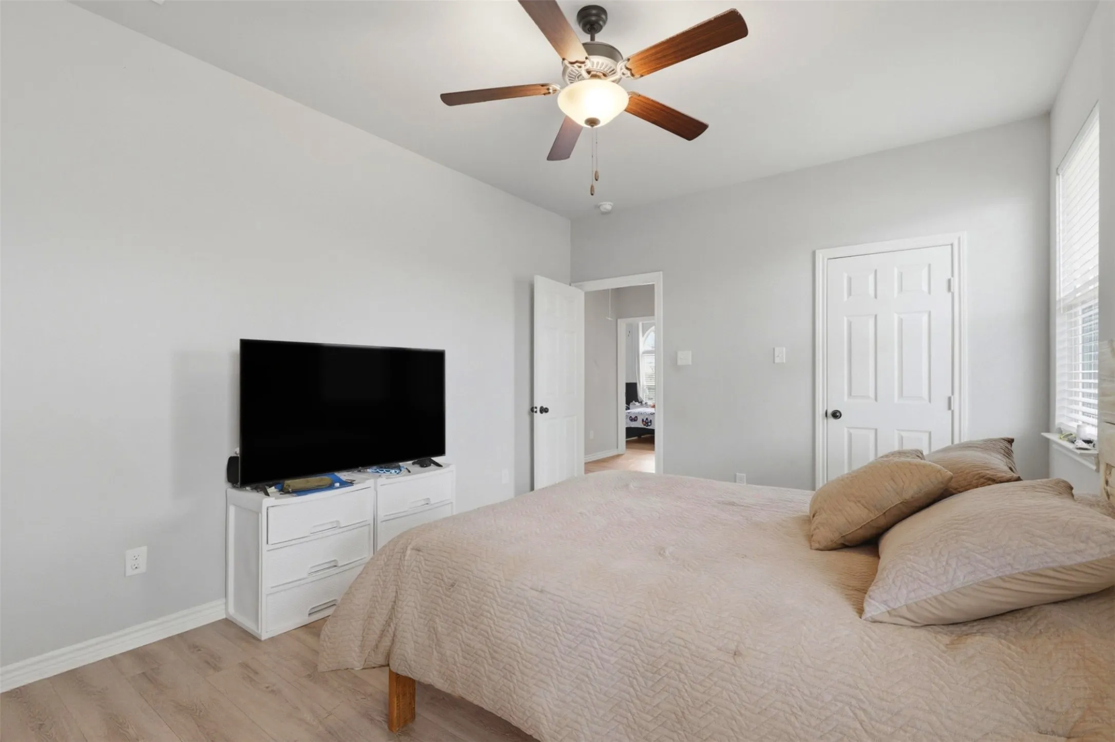 Interior room with light gray walls and wood-finish flooring