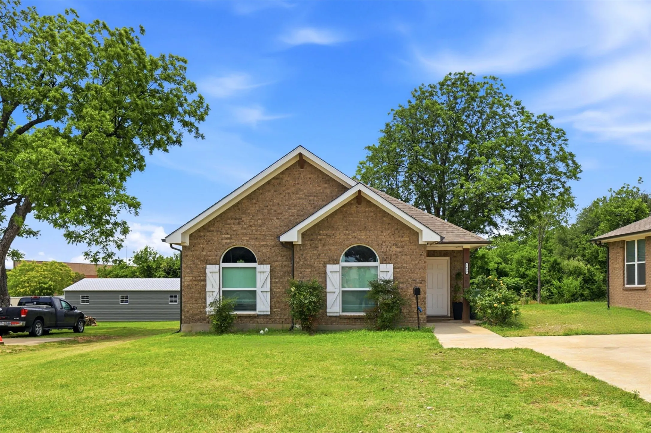 Brick exterior with contrasting white trim and decorative shutters