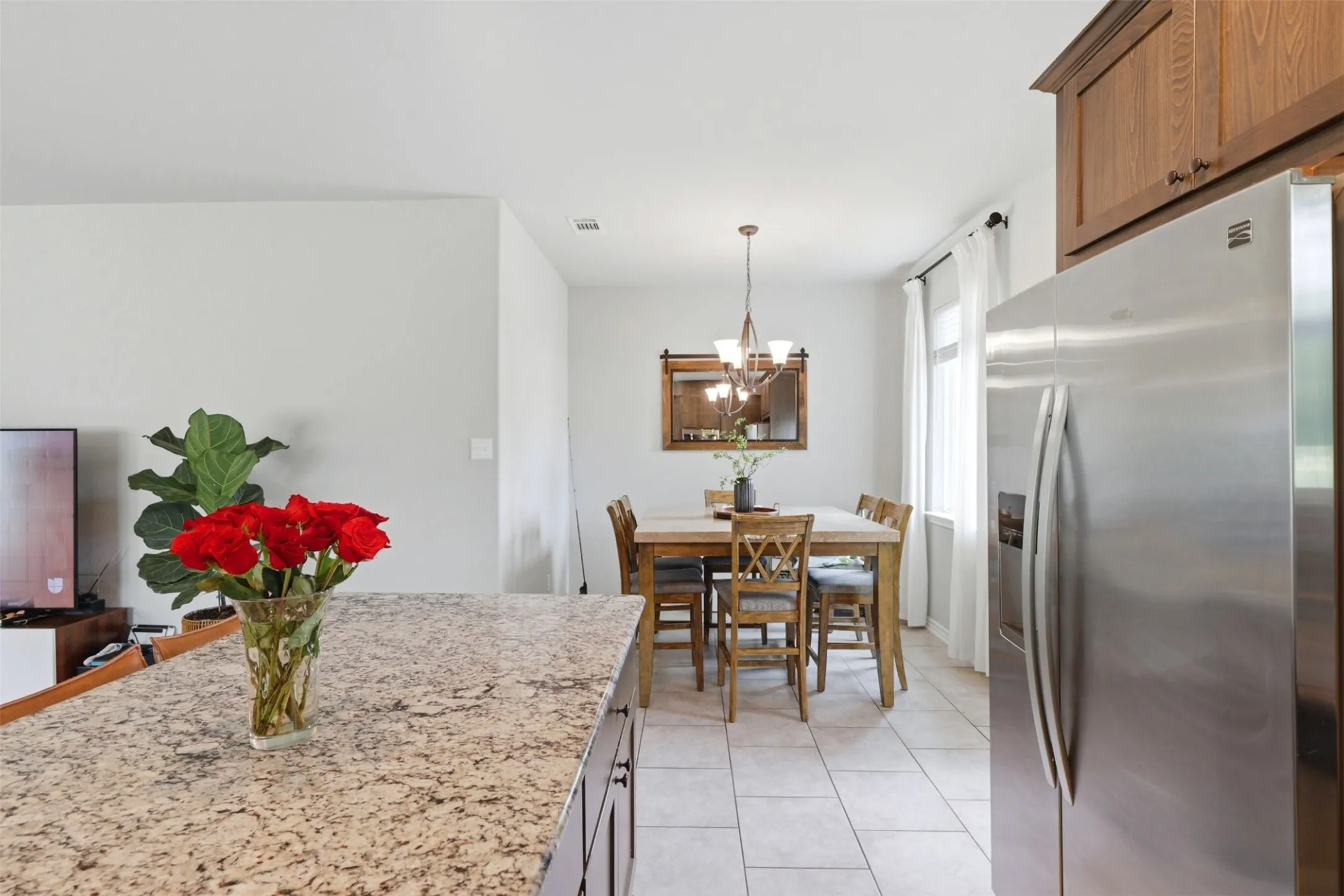 Kitchen island with a granite-style countertop and dark wood-finish cabinetry