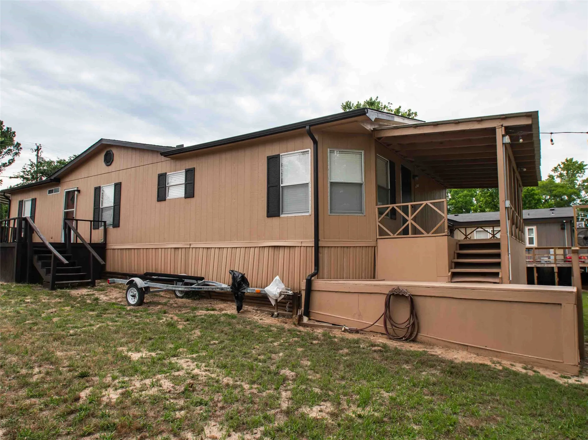 home has large covered porch facing the water