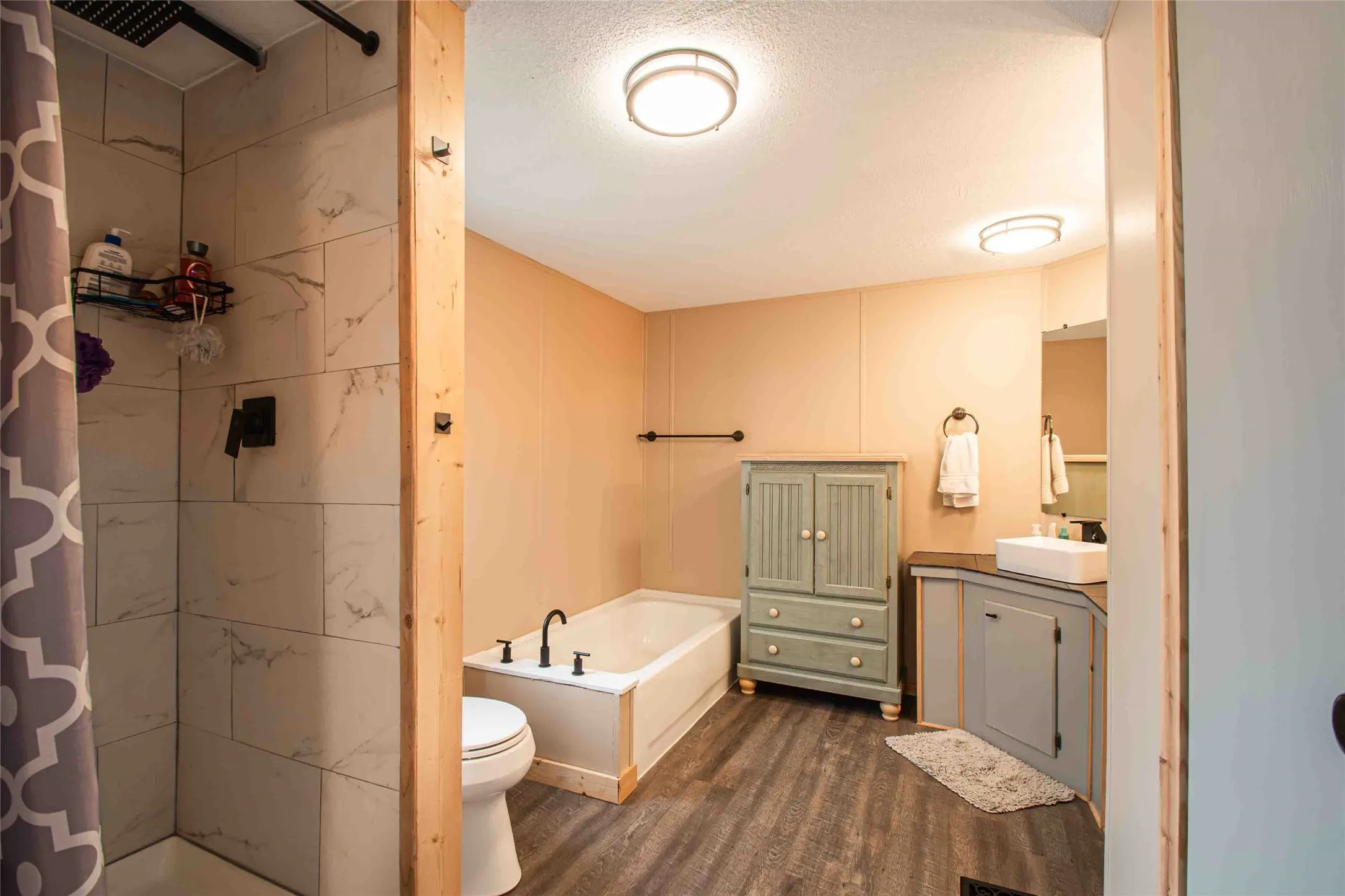 Shower and tub in spacious bathroom