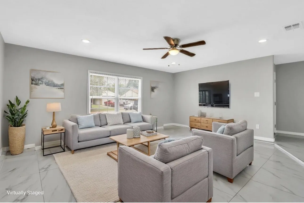 Living area featuring light gray walls, large window, ceiling fan with light fixture, recessed lighting, and large format tile flooring