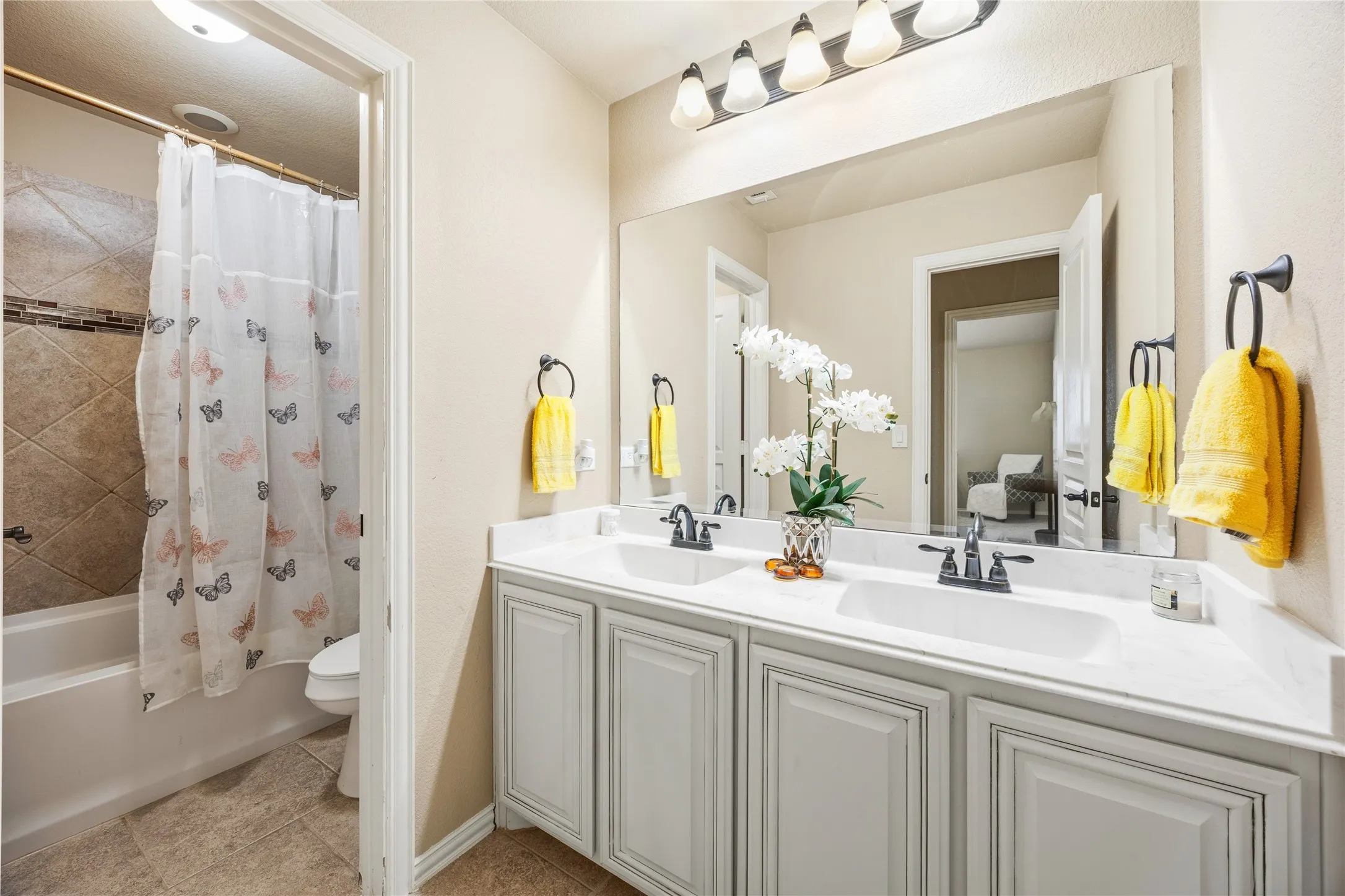 2nd floor shared bathroom for bedroom 3, 4, and 5. Dual sink vanity with white countertop and shower, tub combo.