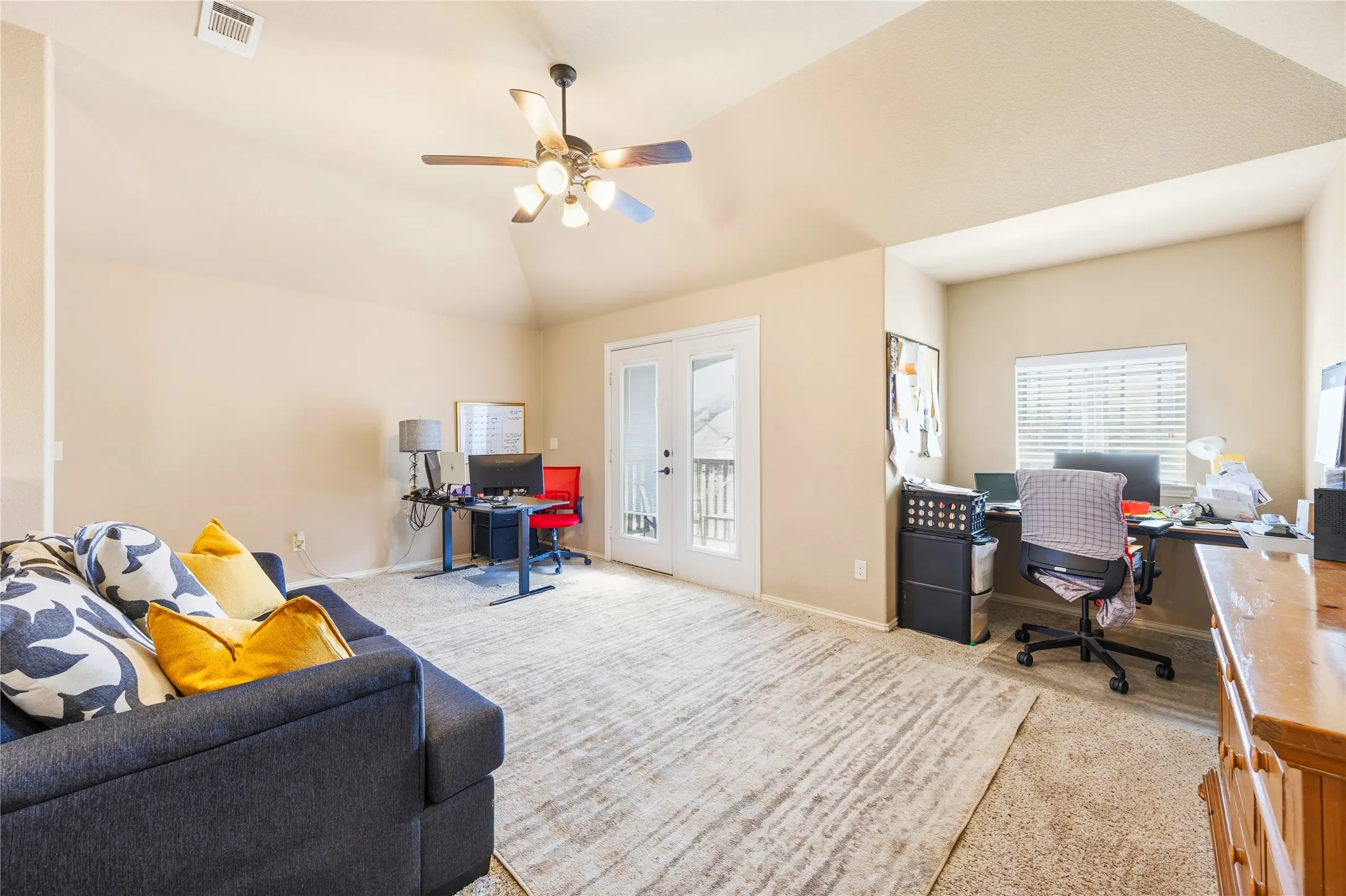 When a shared space is needed, this can be it. Featuring a vaulted ceiling and a ceiling fan with integrated lighting.