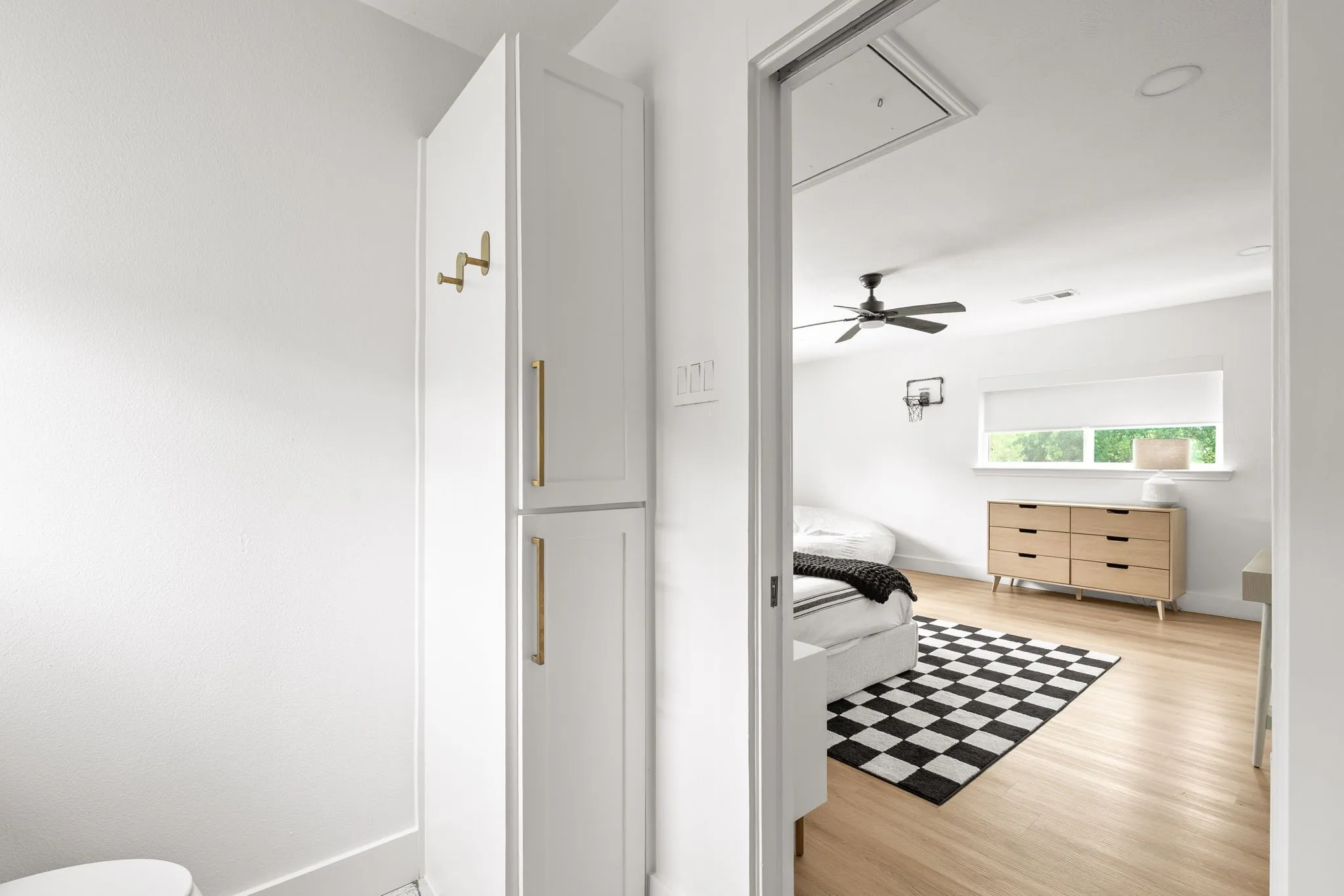 Recessed lighting illuminates wood-finish flooring