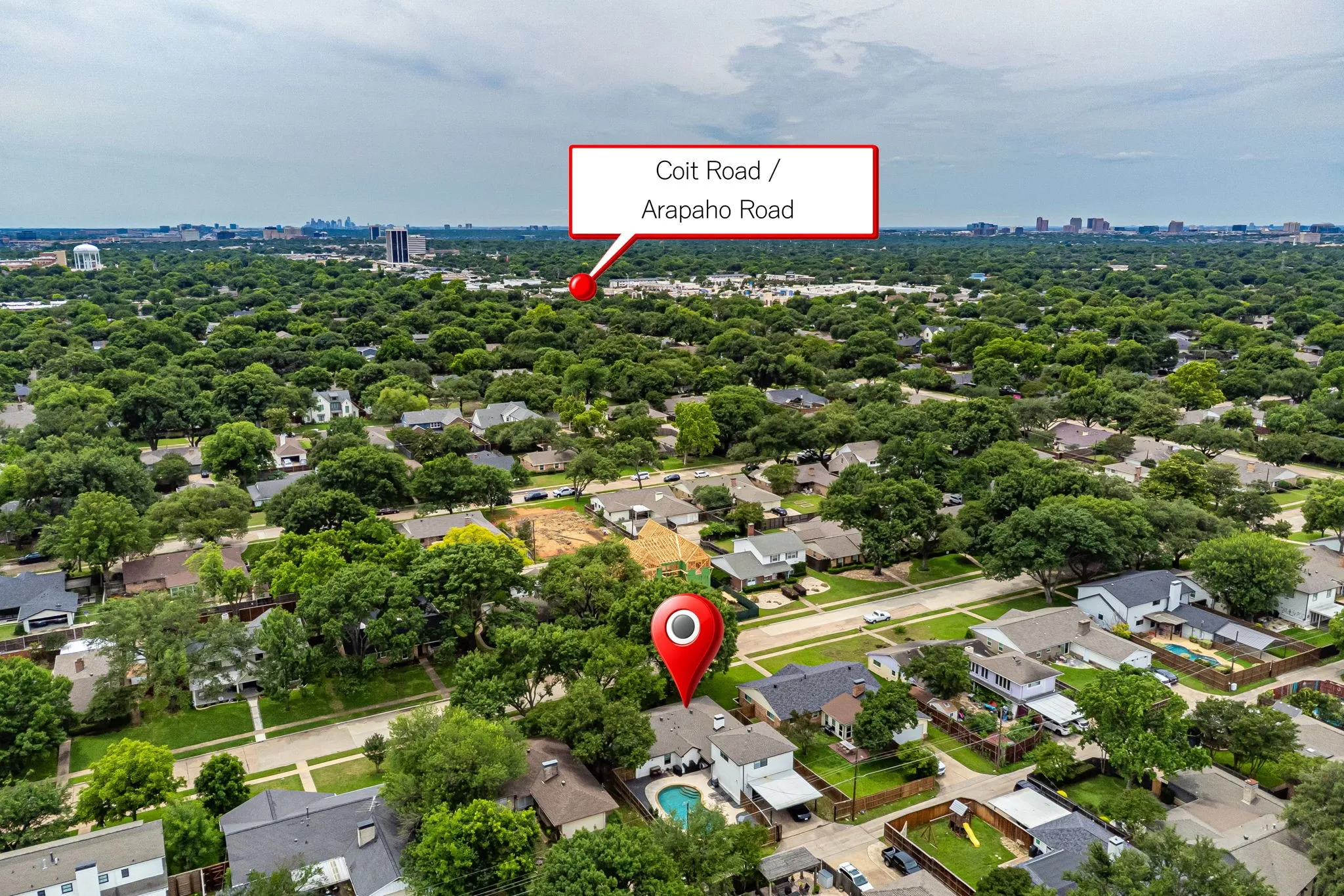 Aerial perspective showcasing a residential area with dense tree canopy