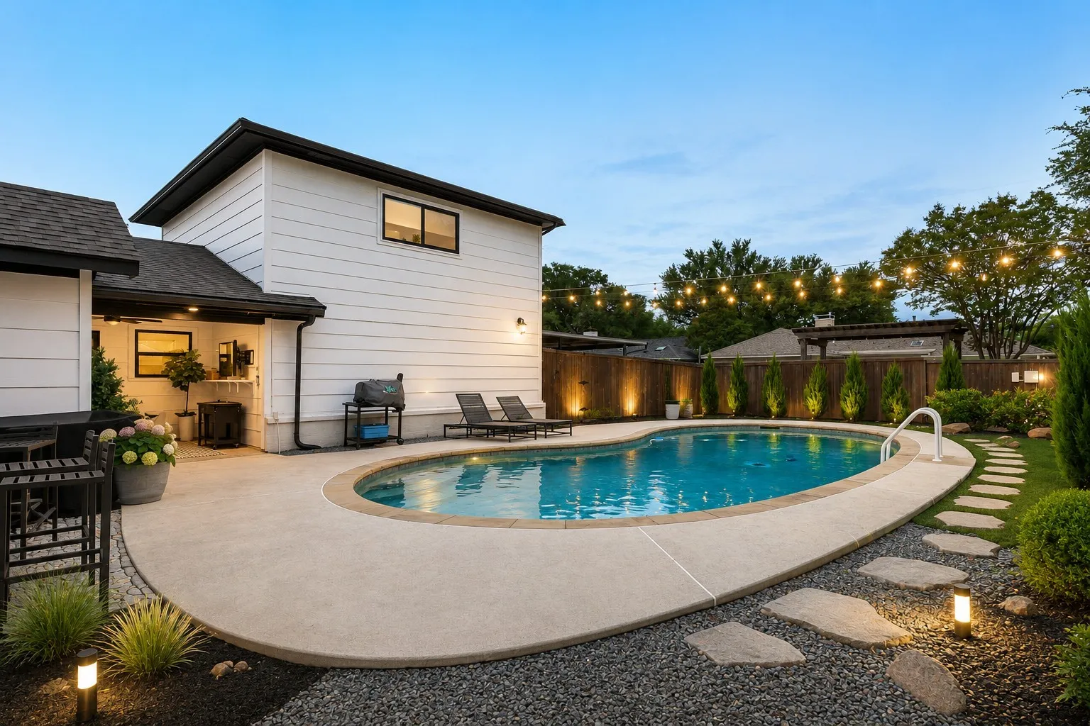 Inviting backyard featuring an in-ground swimming pool with surrounding concrete decking
