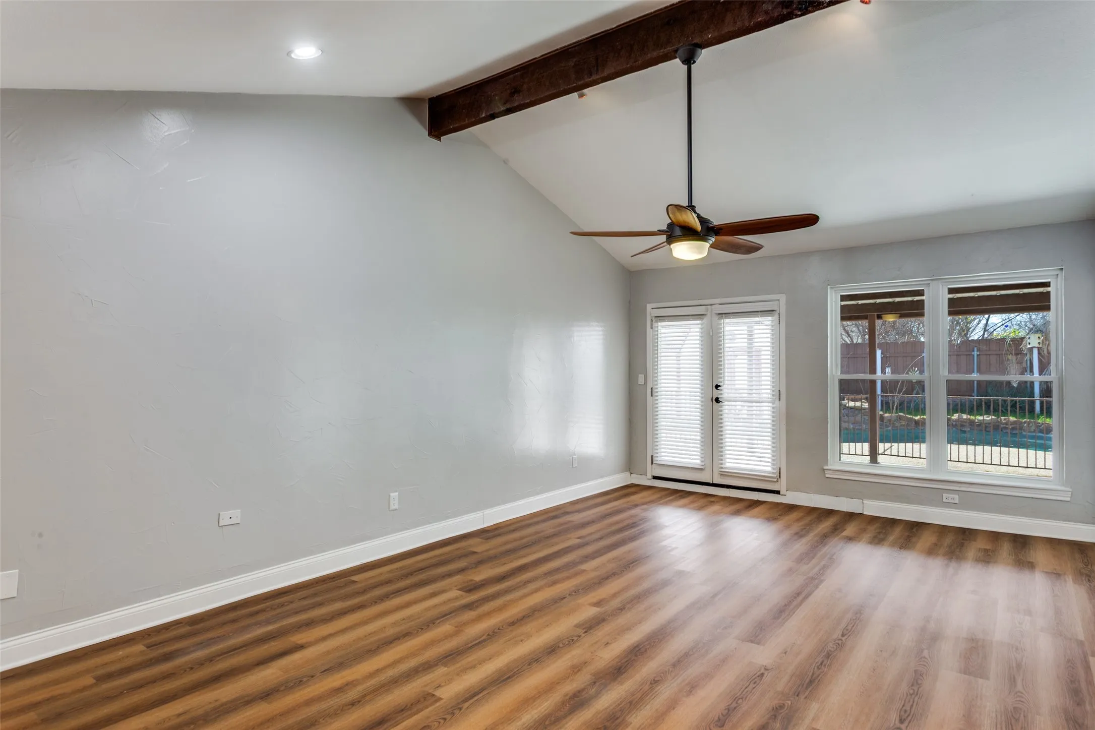 Vaulted ceiling featuring a wood-finish beam and recessed lighting