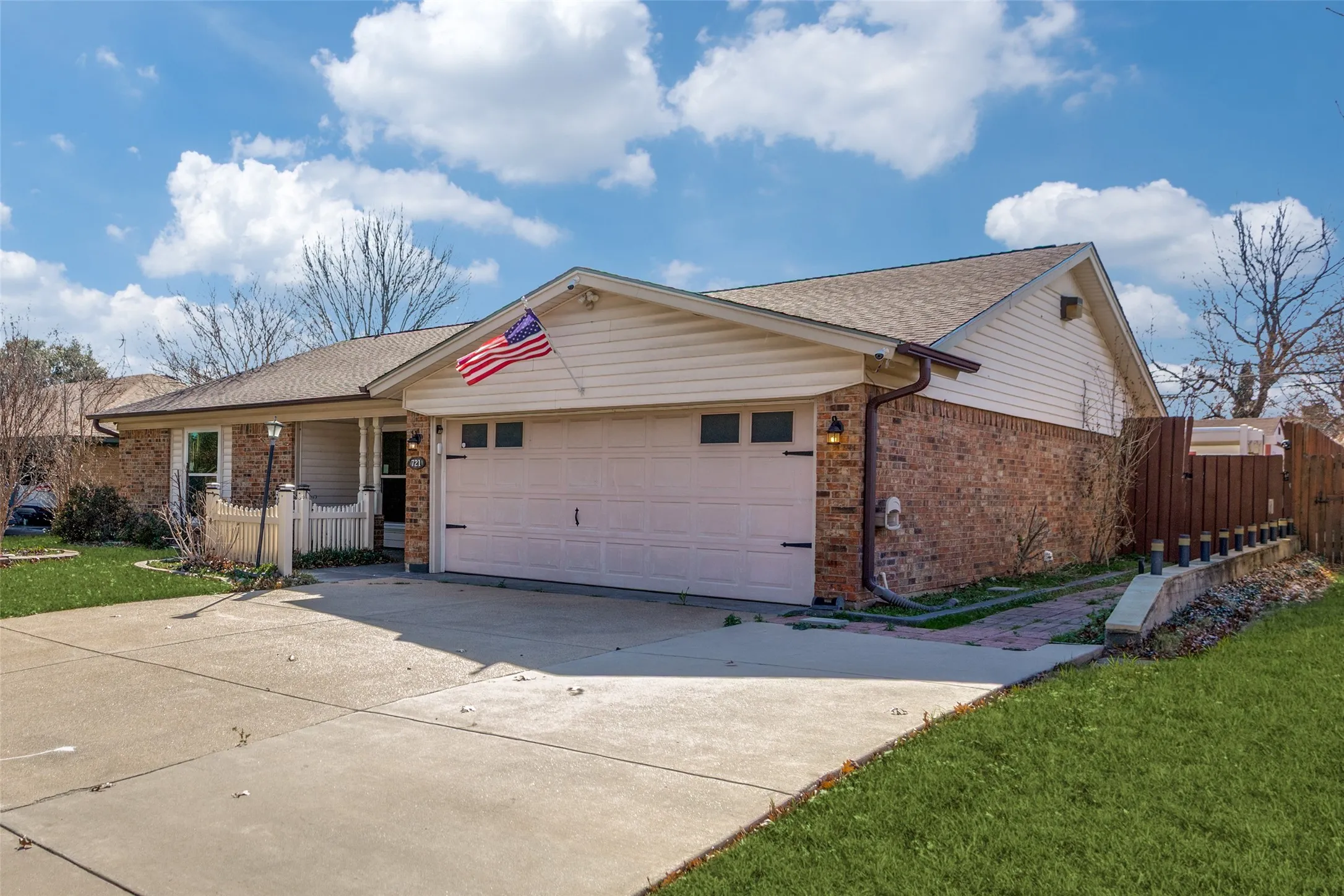 Brick and siding exterior with an attached two-car garage
