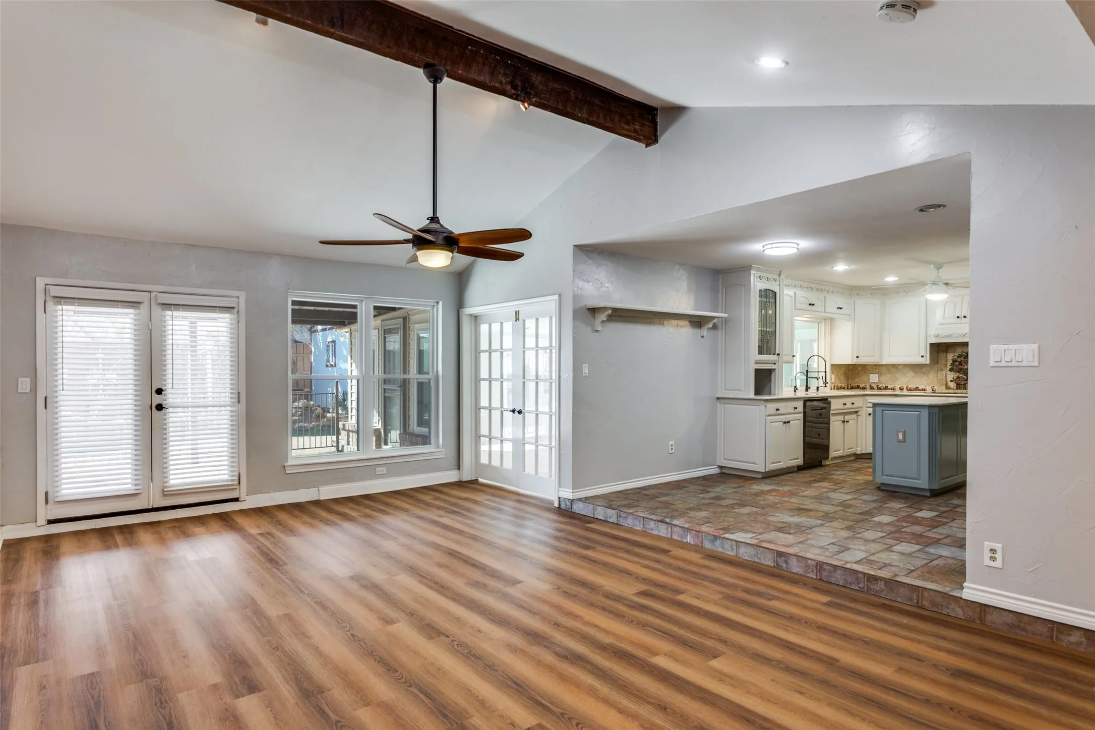 Vaulted ceiling with exposed wood beam and ceiling fan