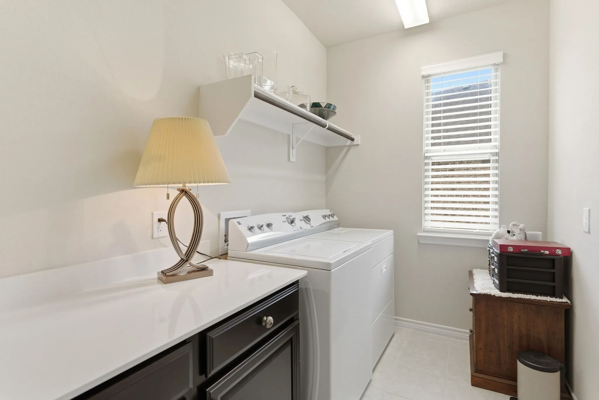 Separate laundry with built in cabinets and folding top.