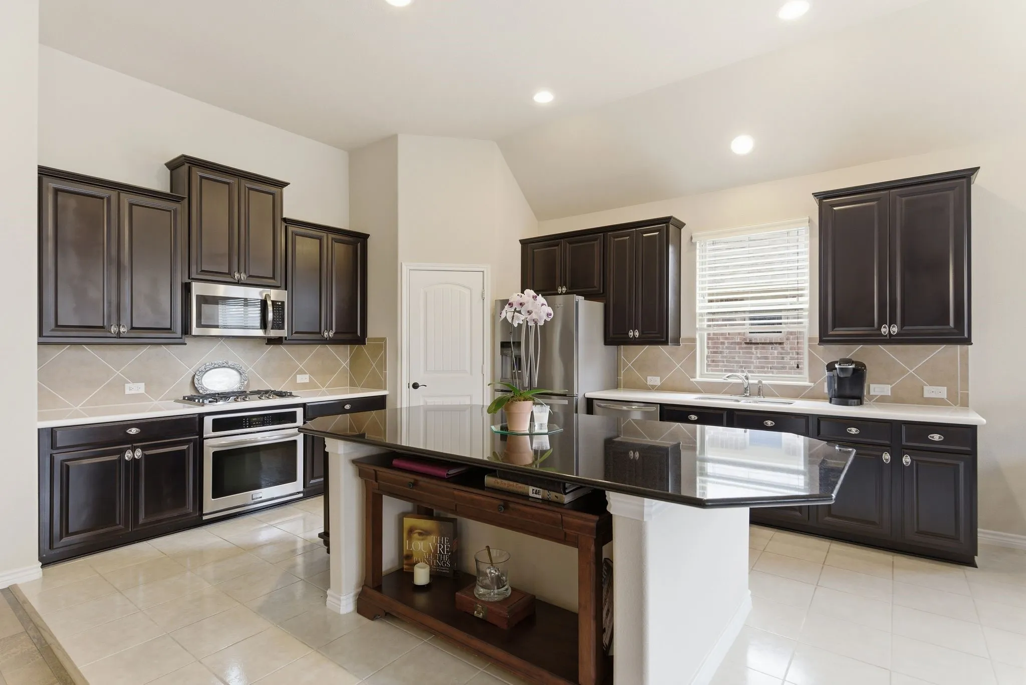 Large, richly appointed kitchen with custom finishes