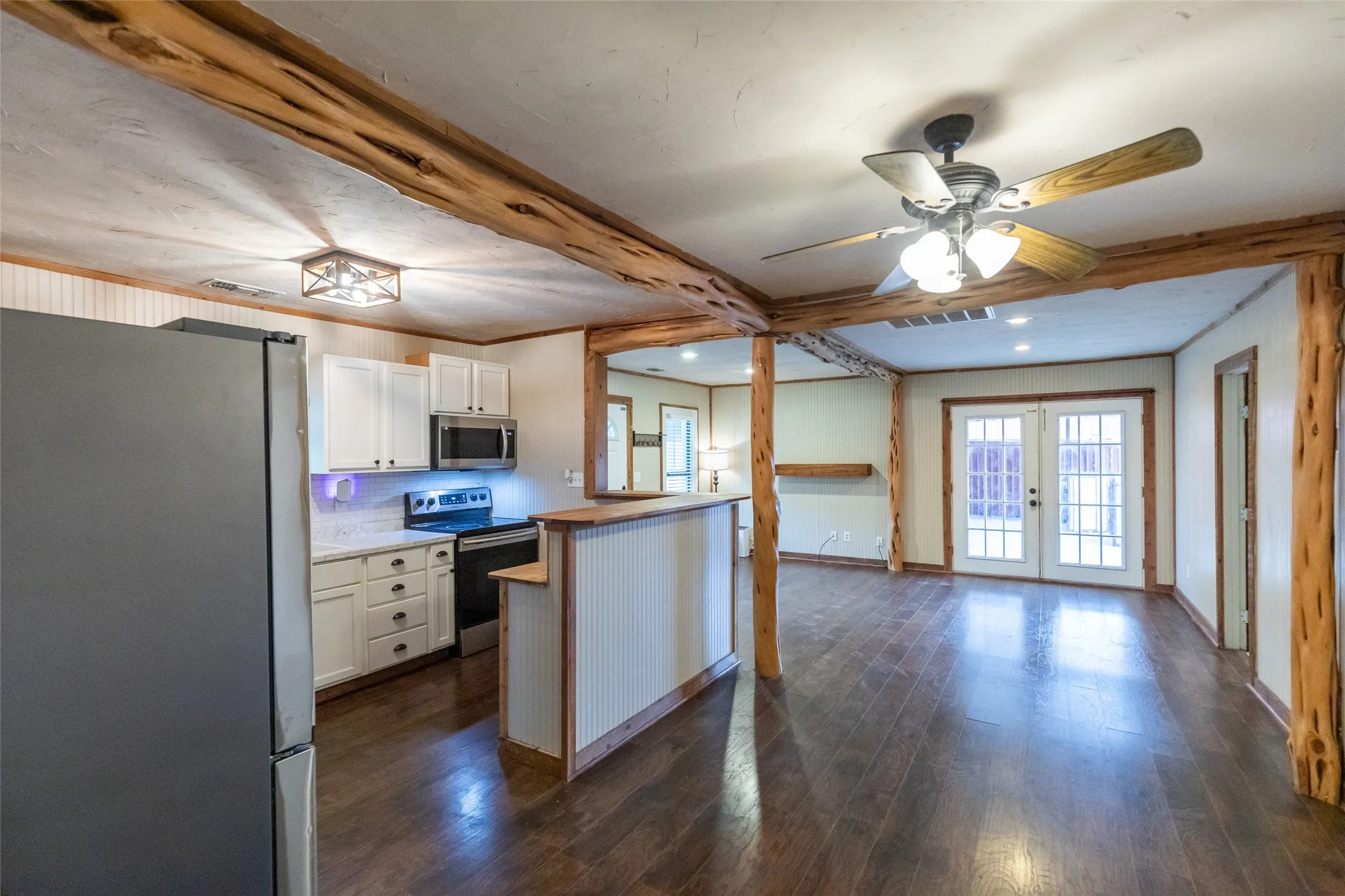 Kitchen and living area featuring dark wood-finish flooring