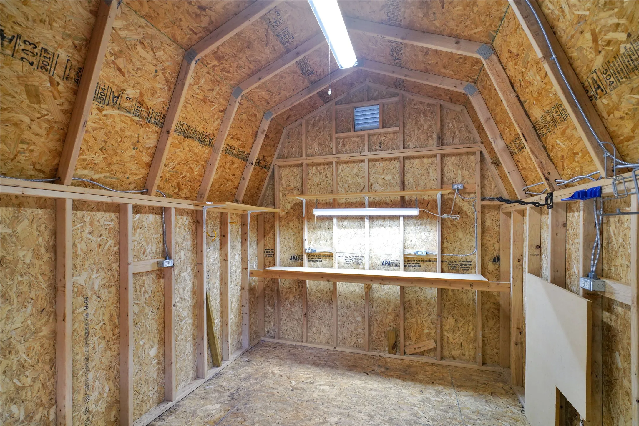 Interior structure with exposed wood framing and oriented strand board walls