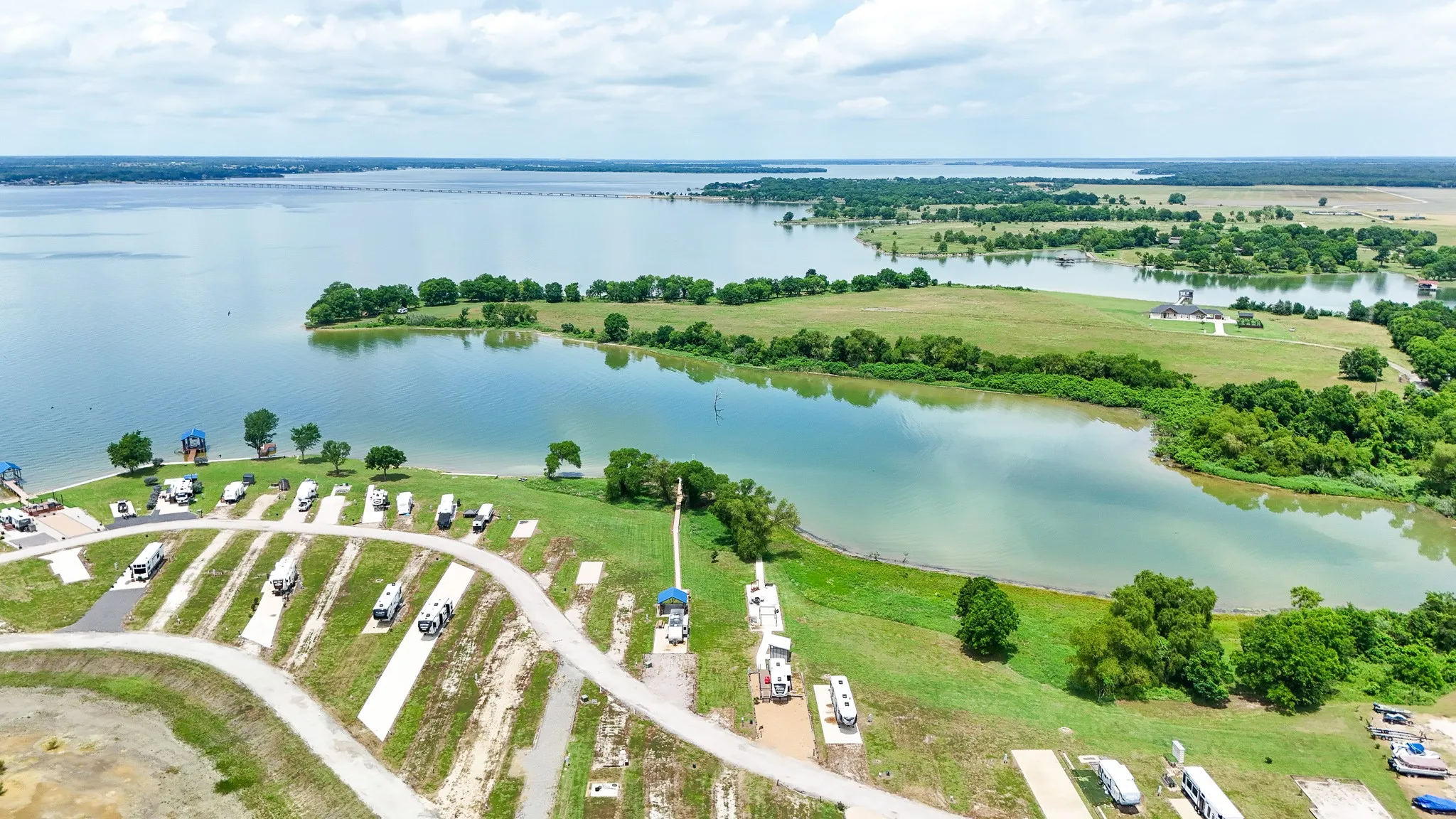 Expansive lakefront property featuring multiple RV sites with paved access