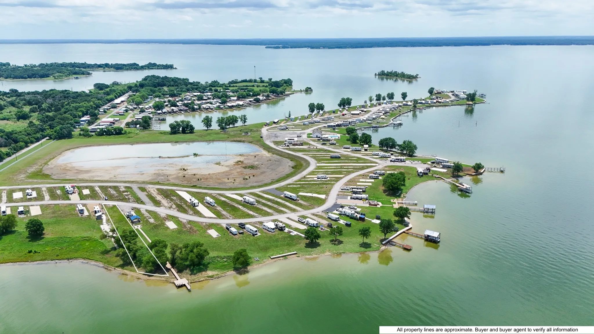 Expansive waterfront property featuring direct lake access, multiple boat docks, and numerous RV spaces