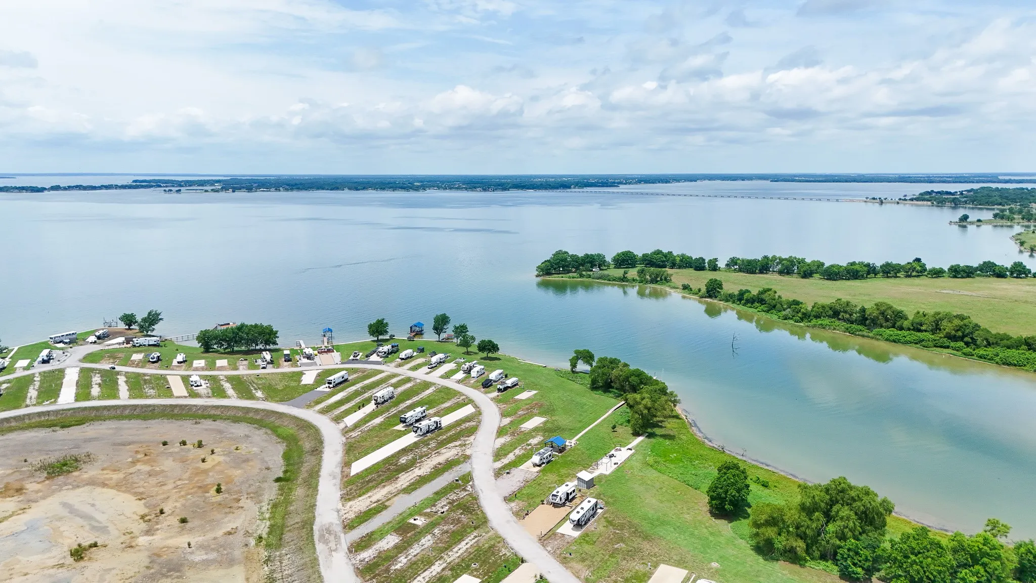 Expansive waterfront property featuring a large body of water, a winding channel, and multiple land parcels