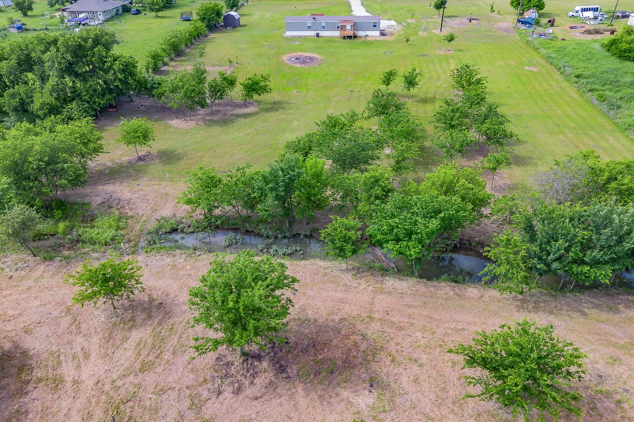 Peaceful creek running along the back portion of the property creating a private country setting.