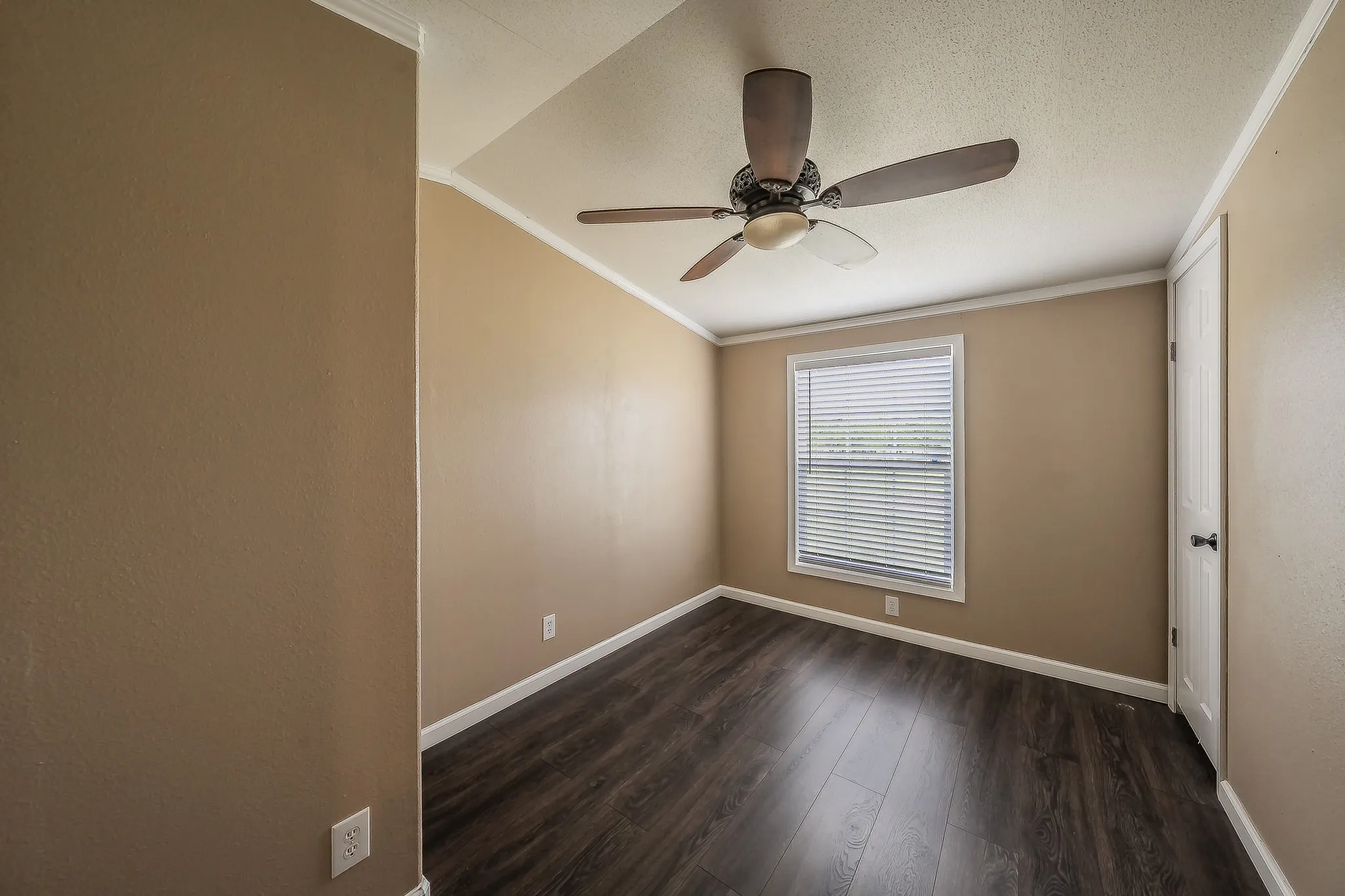 Spacious third bedroom with ceiling fan