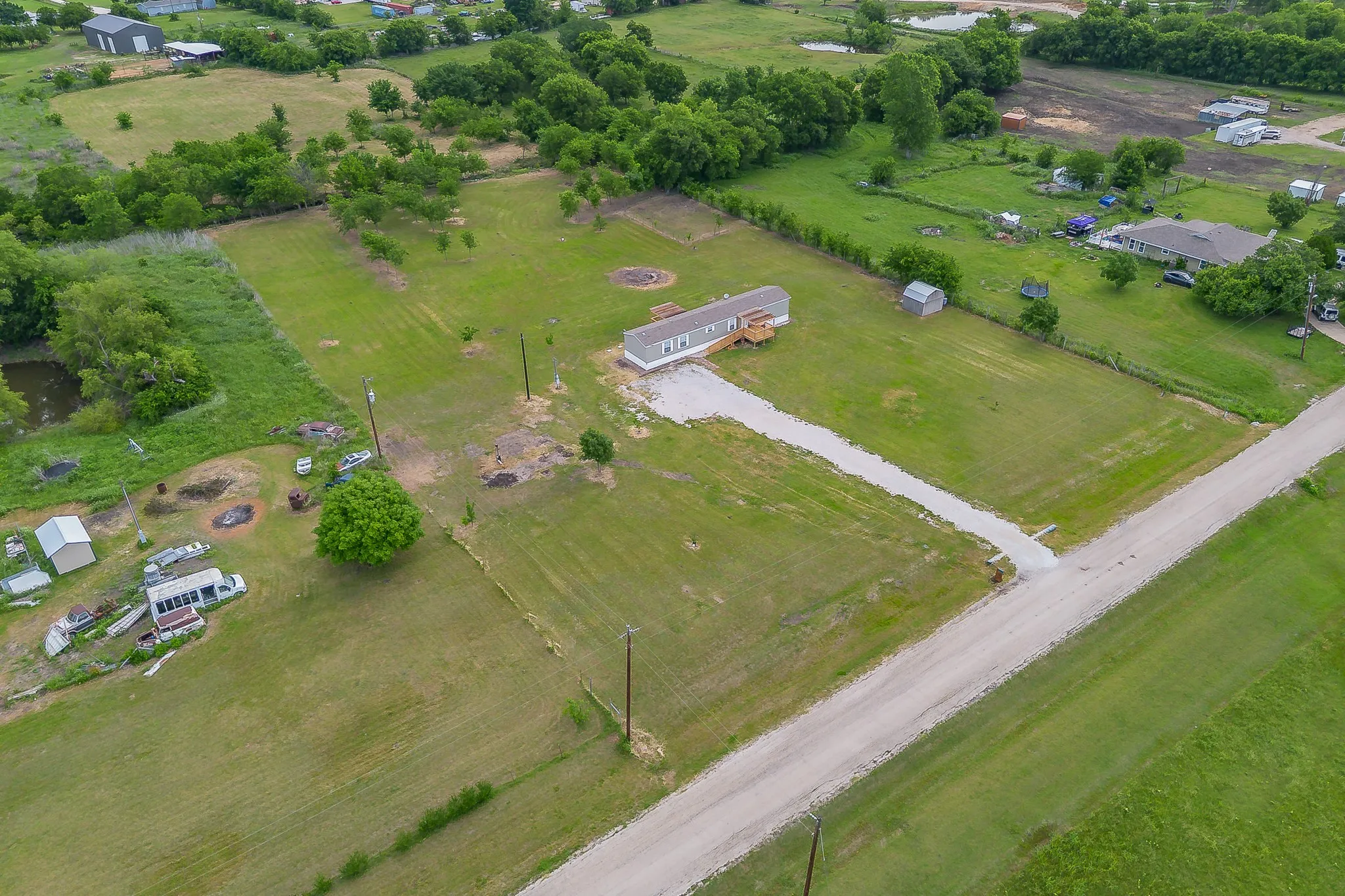 Aerial view showcasing the full layout of the property and surrounding acreage.