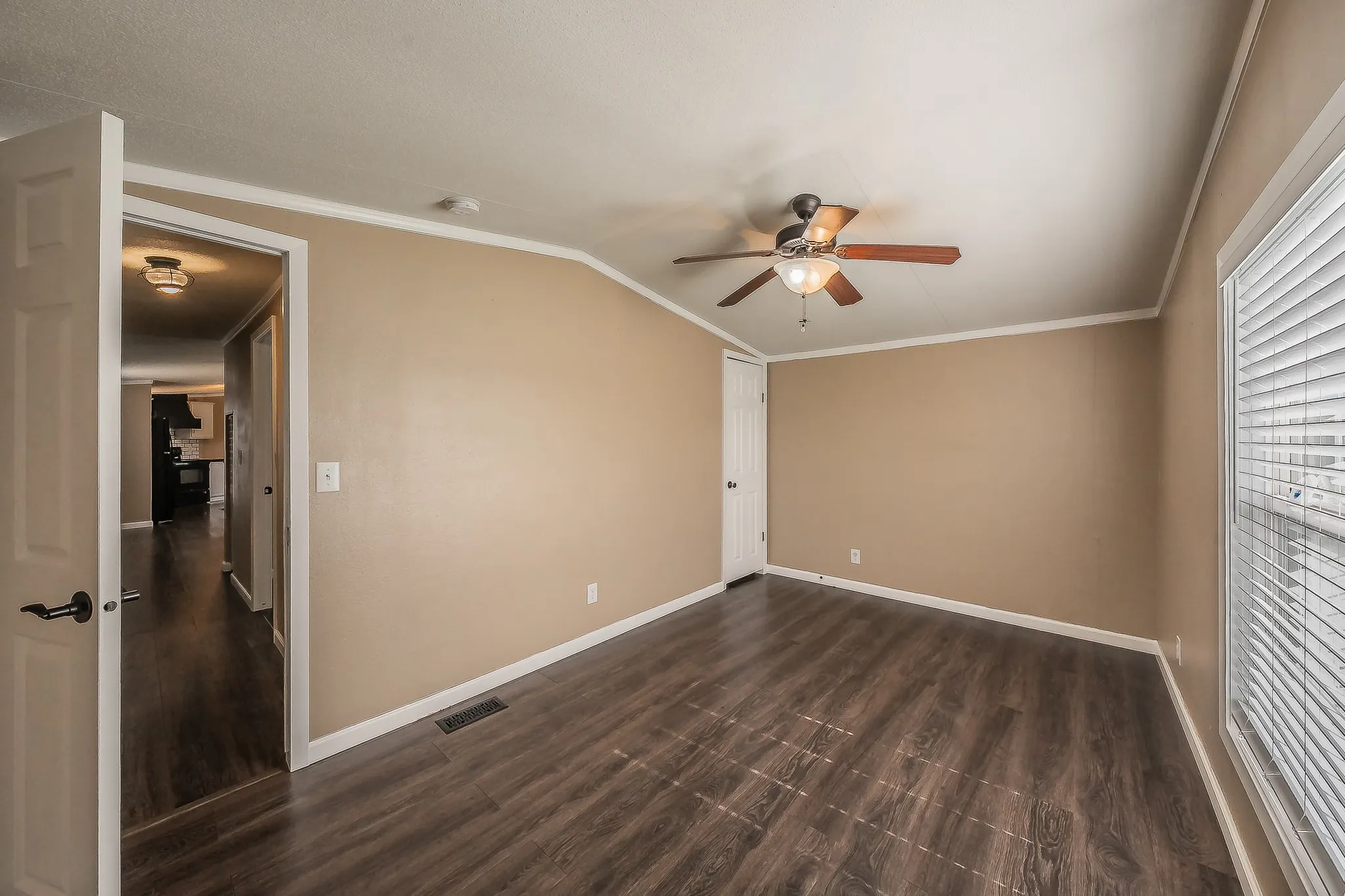 Second bedroom with ceiling fan and natural light.