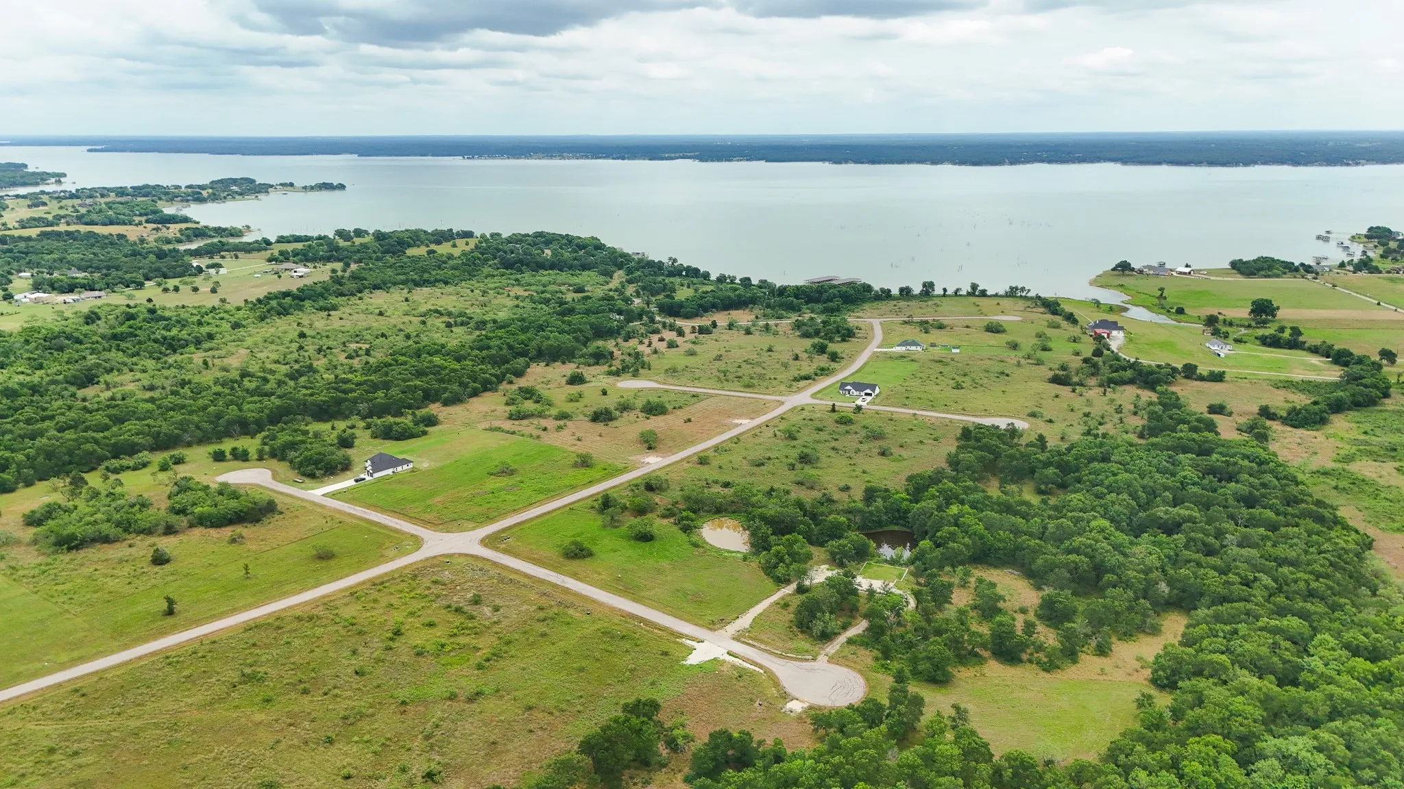 Expansive land parcels featuring established roadways and mature tree clusters