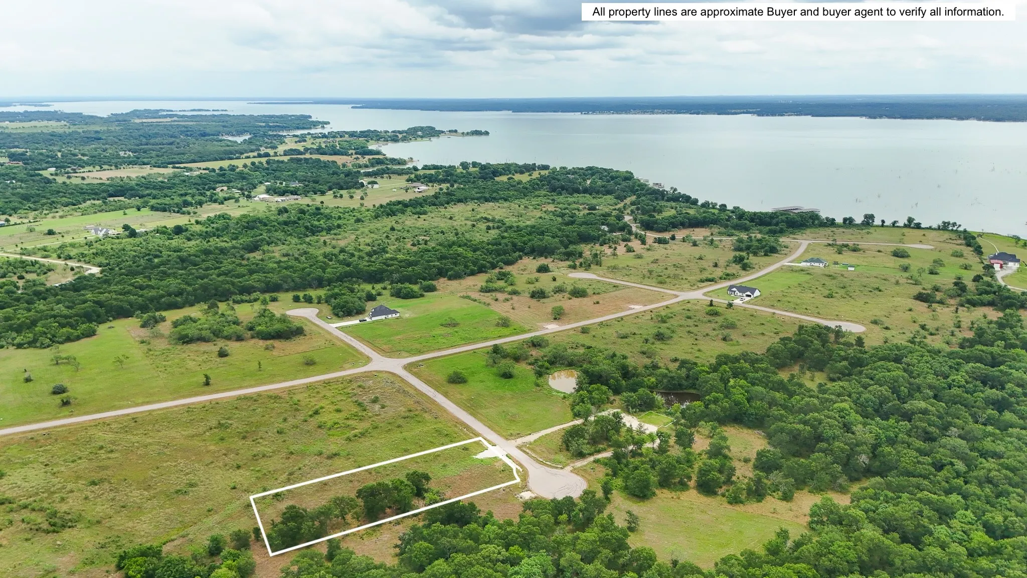 Expansive lot featuring a natural tree line, partial clearing, and direct access to a paved road
