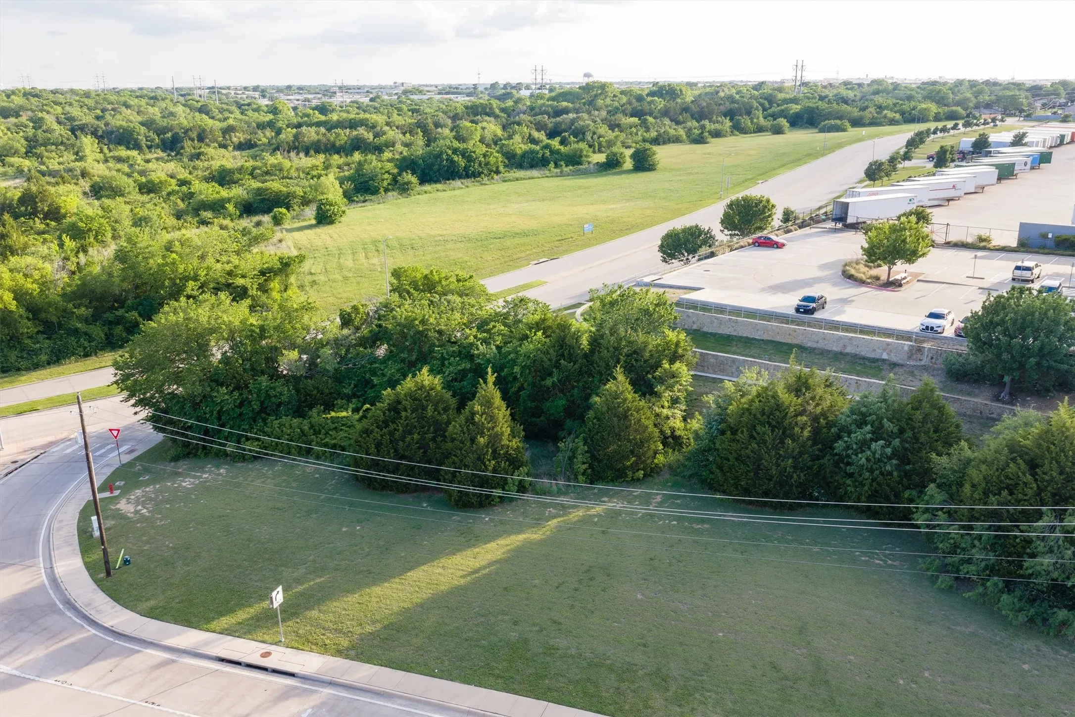 Expansive green space featuring mature trees and a manicured lawn