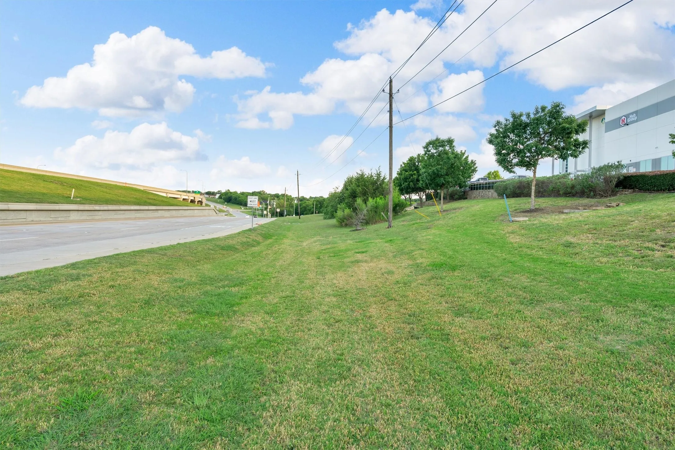 Expansive grassy area featuring a gentle slope