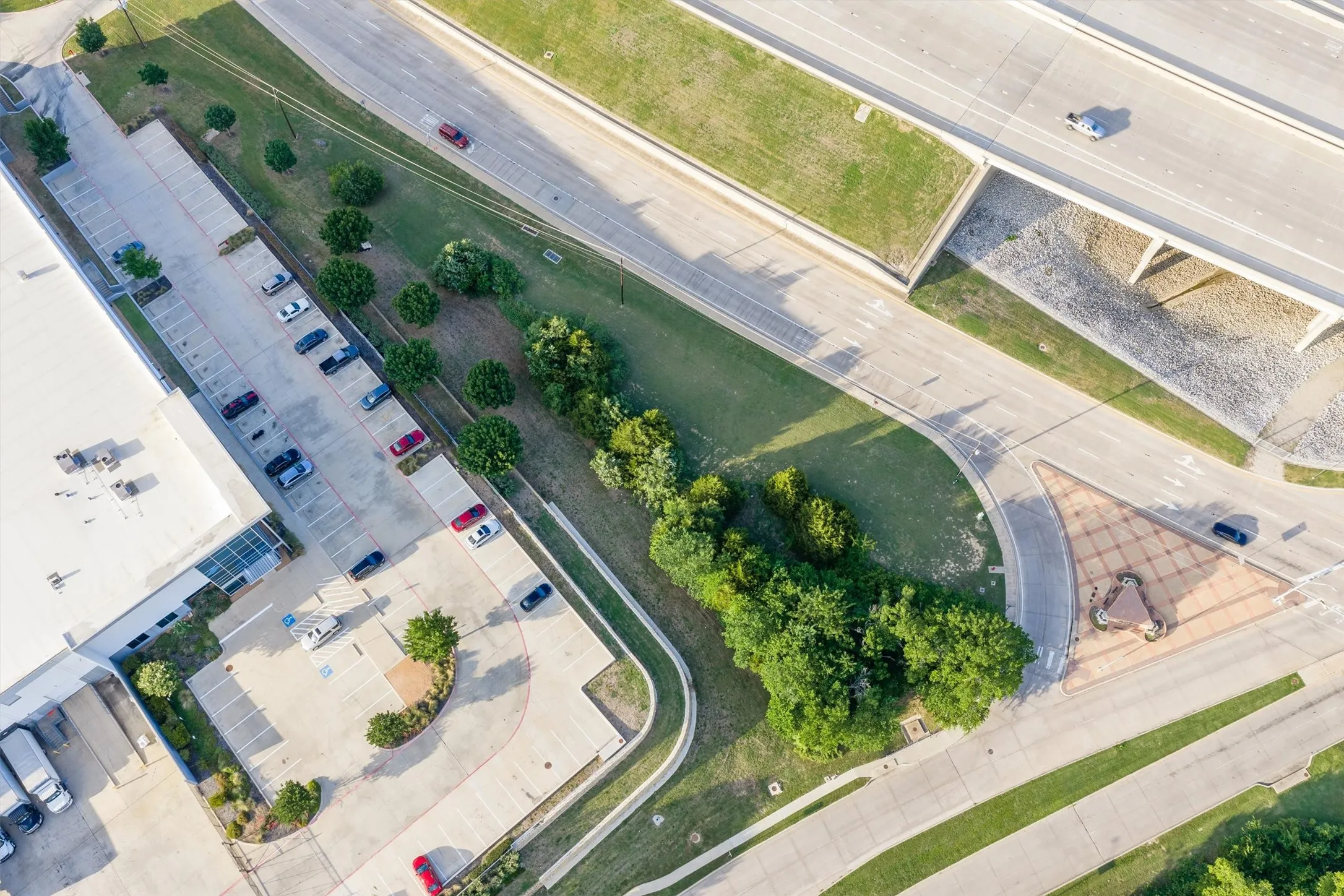 Aerial perspective highlighting a commercial building with an expansive parking lot