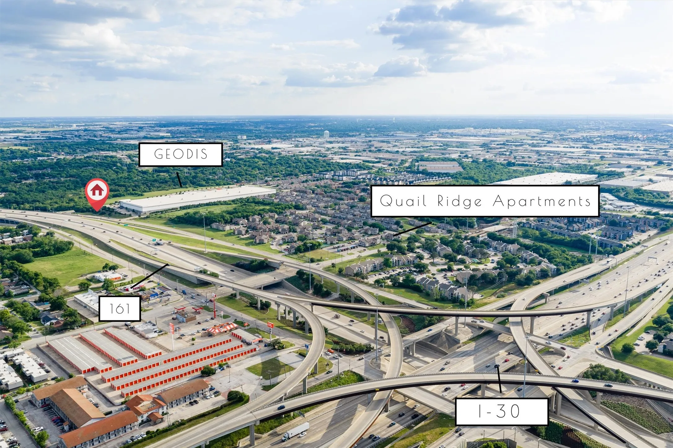 Aerial perspective showcasing an extensive highway interchange with multiple elevated roads and a dense urban landscape