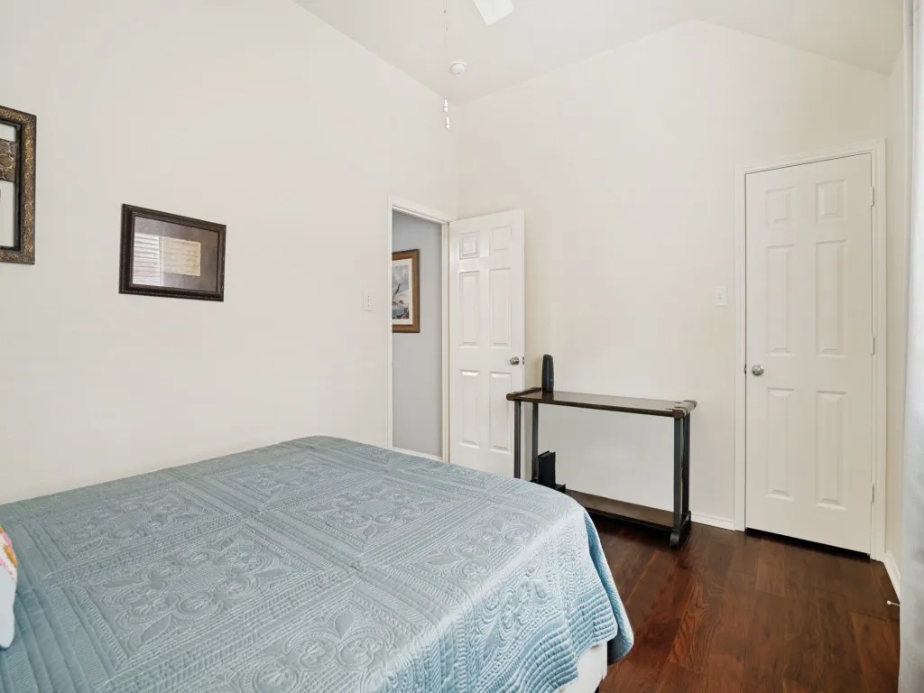 Room featuring vaulted ceilings and dark wood-finish flooring