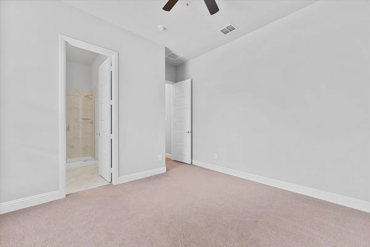 Carpeted room featuring light gray wall paint and white baseboards
