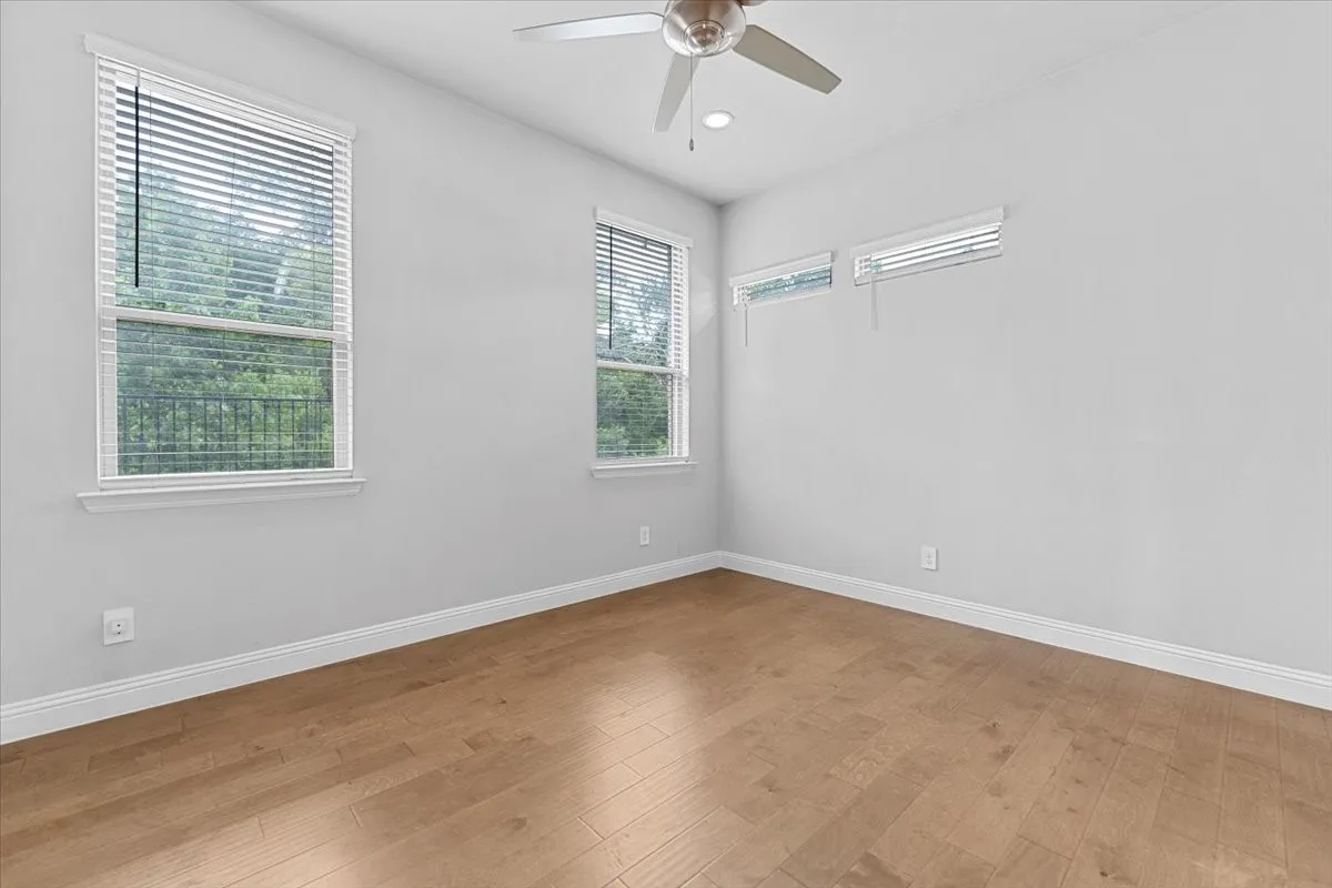 Light wood-finish flooring, white walls, and white trim