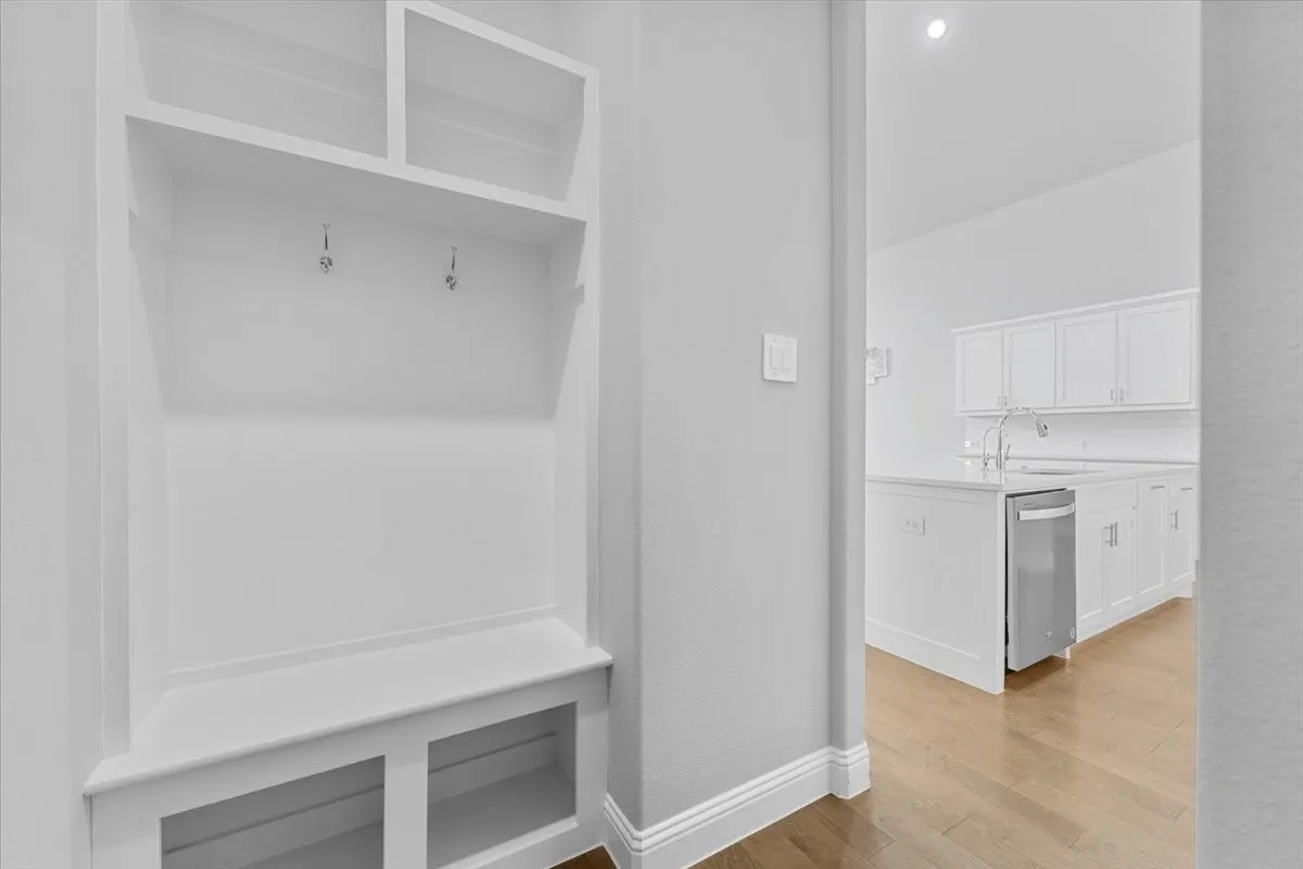 Built-in mudroom bench with shelving and coat hooks