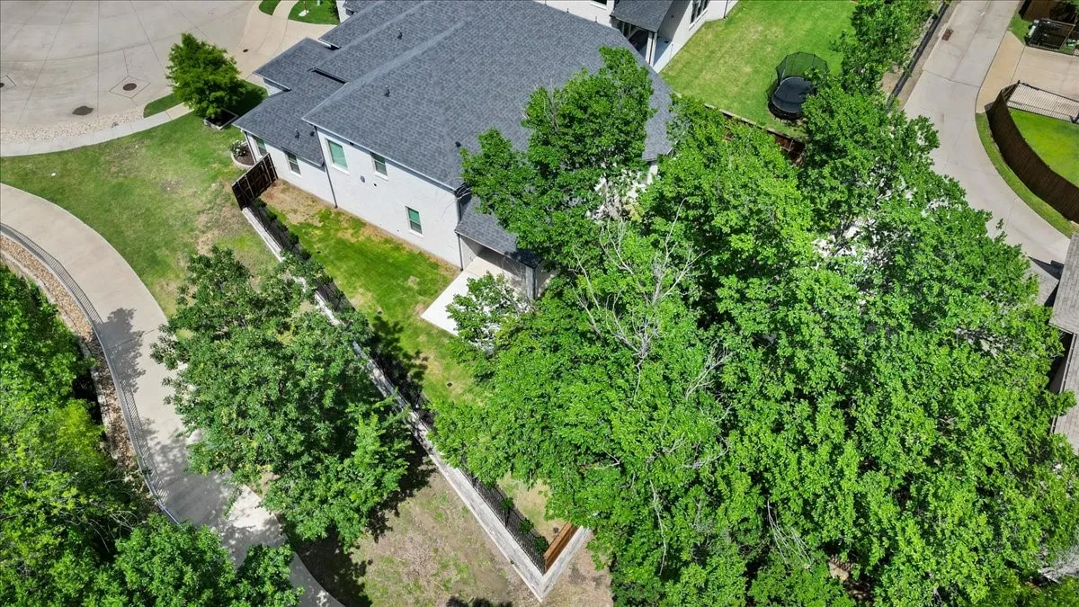 Contemporary residence with gray siding and dark shingle roof