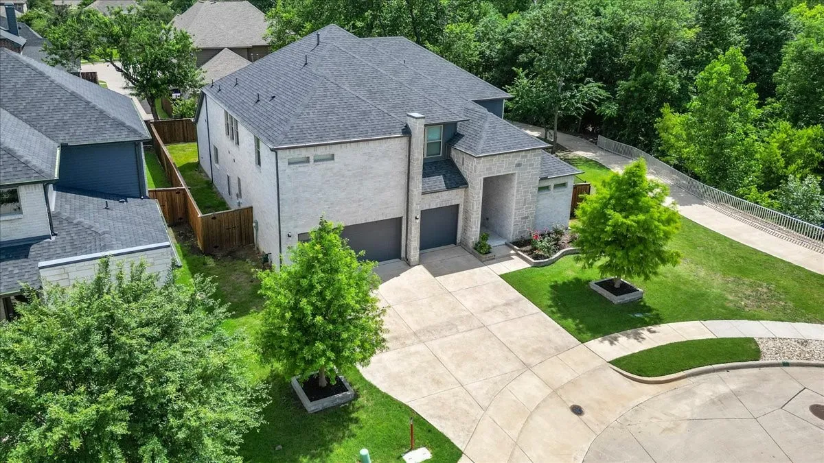 Light-colored brick exterior with a dark grey shingle roof