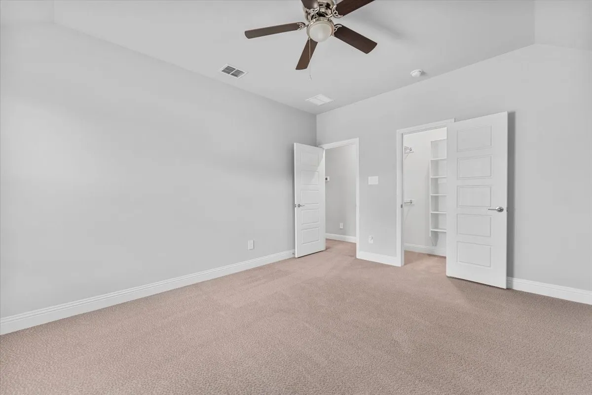Neutral-toned carpeting complements the light gray wall finish