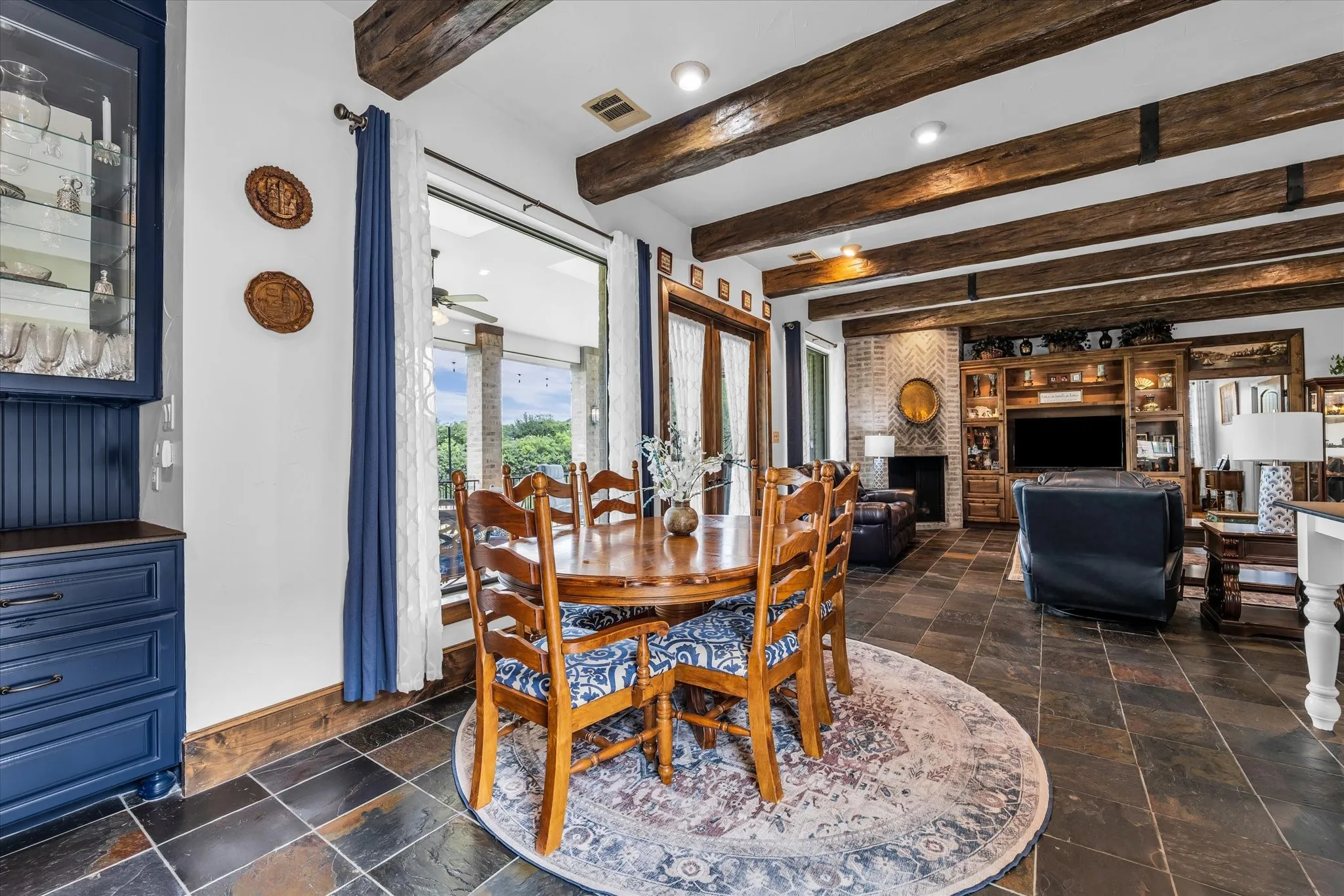 Dining area with wood-finish flooring and exposed ceiling beams