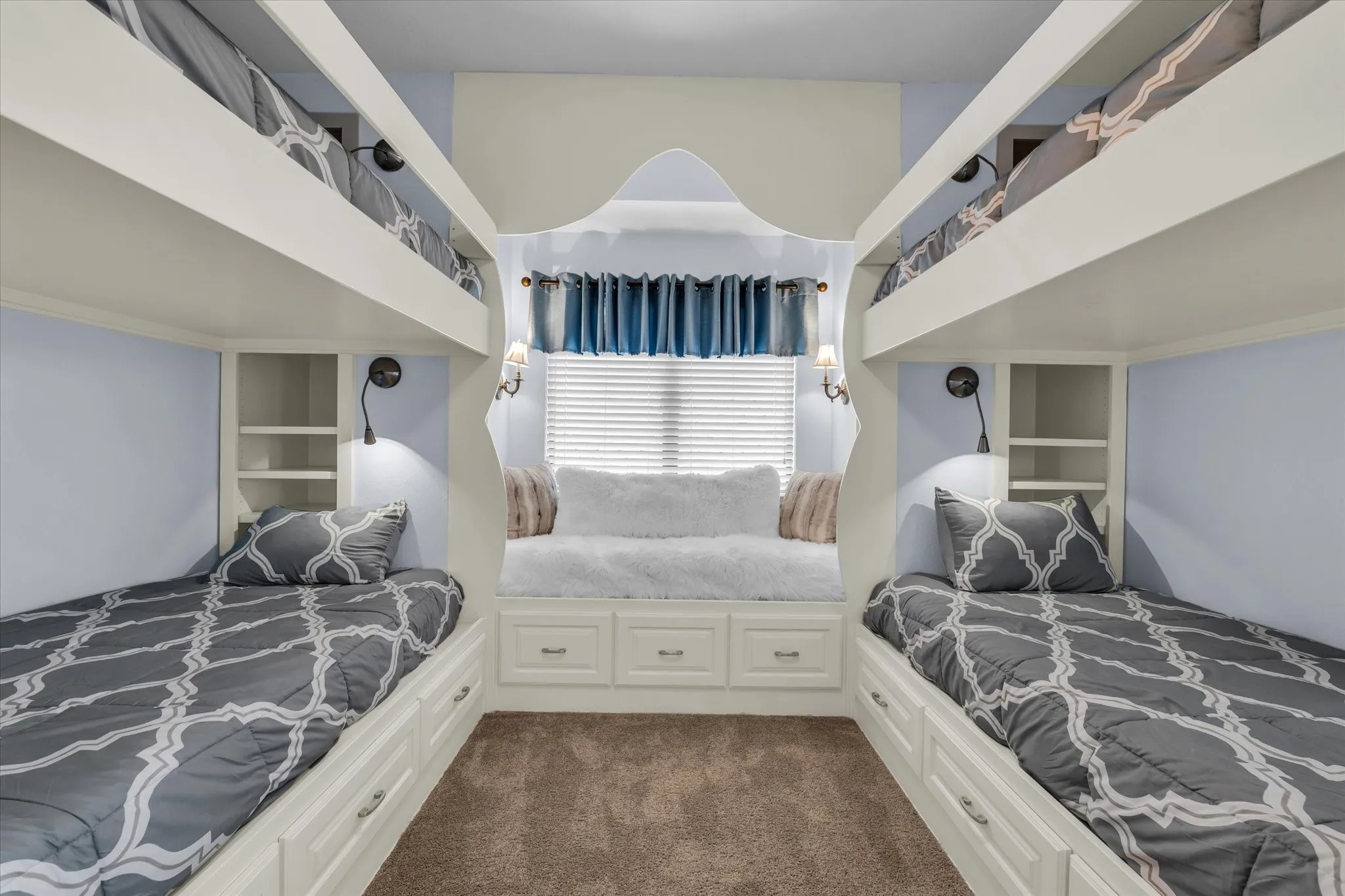 Built-in bunk beds with individual reading lights and integrated shelving