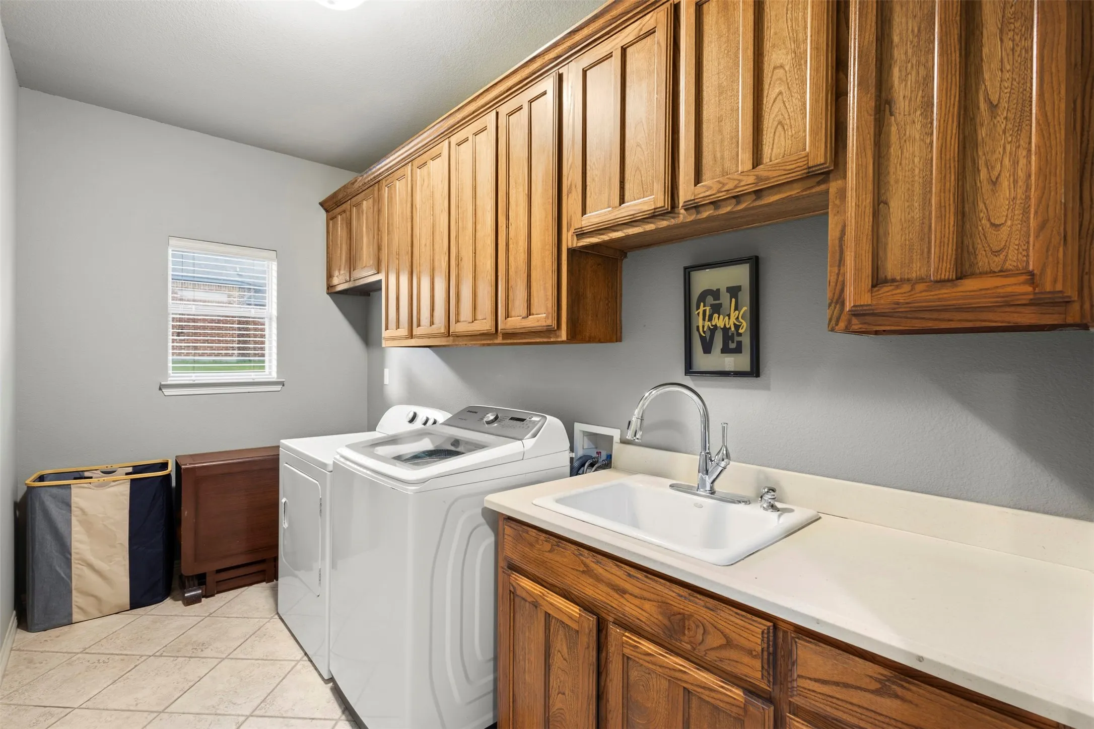 Laundry room with sink and plenty of cabinets